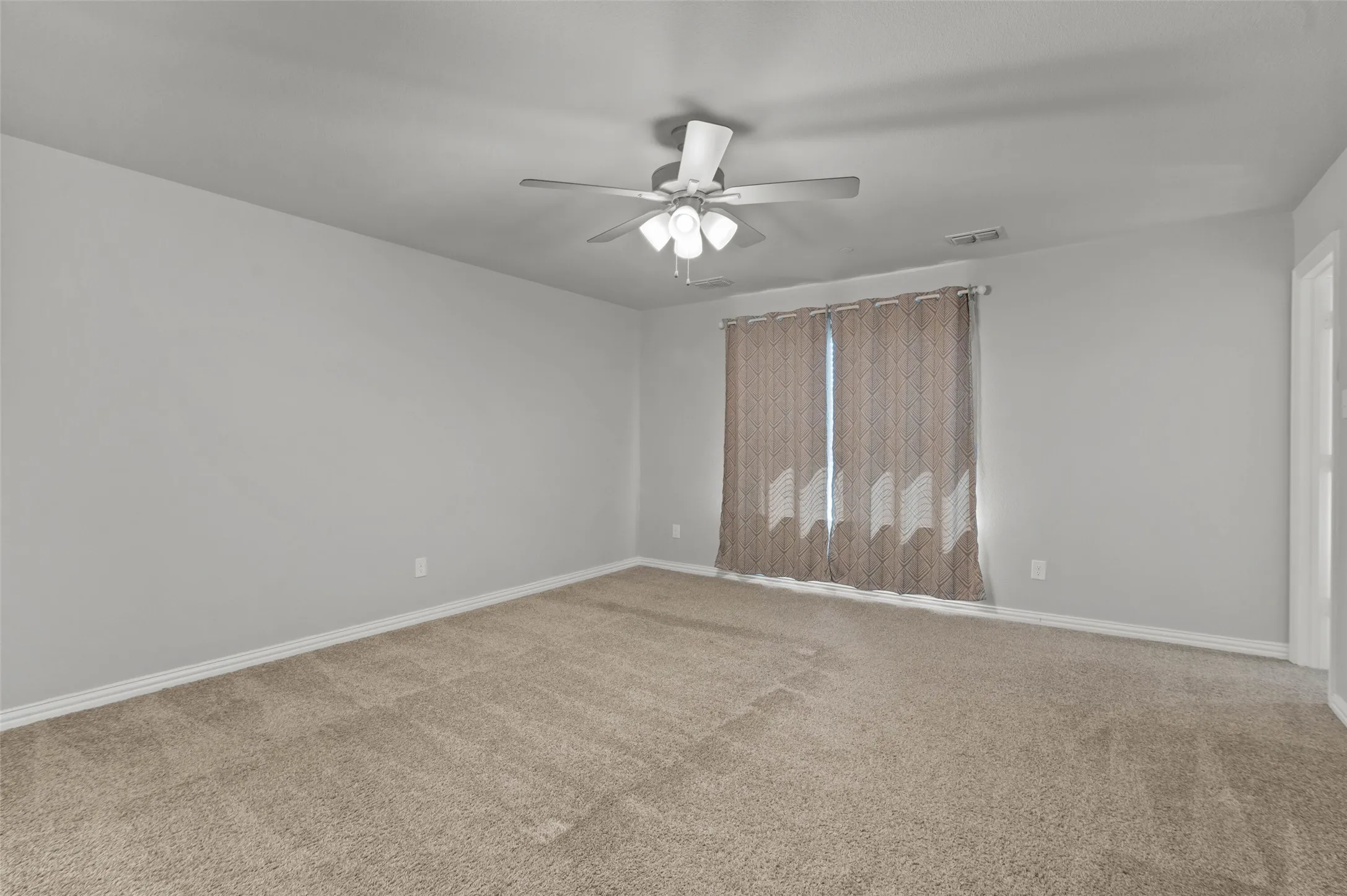 Large primary bedroom with two walk in closets and ensuite bathroom.