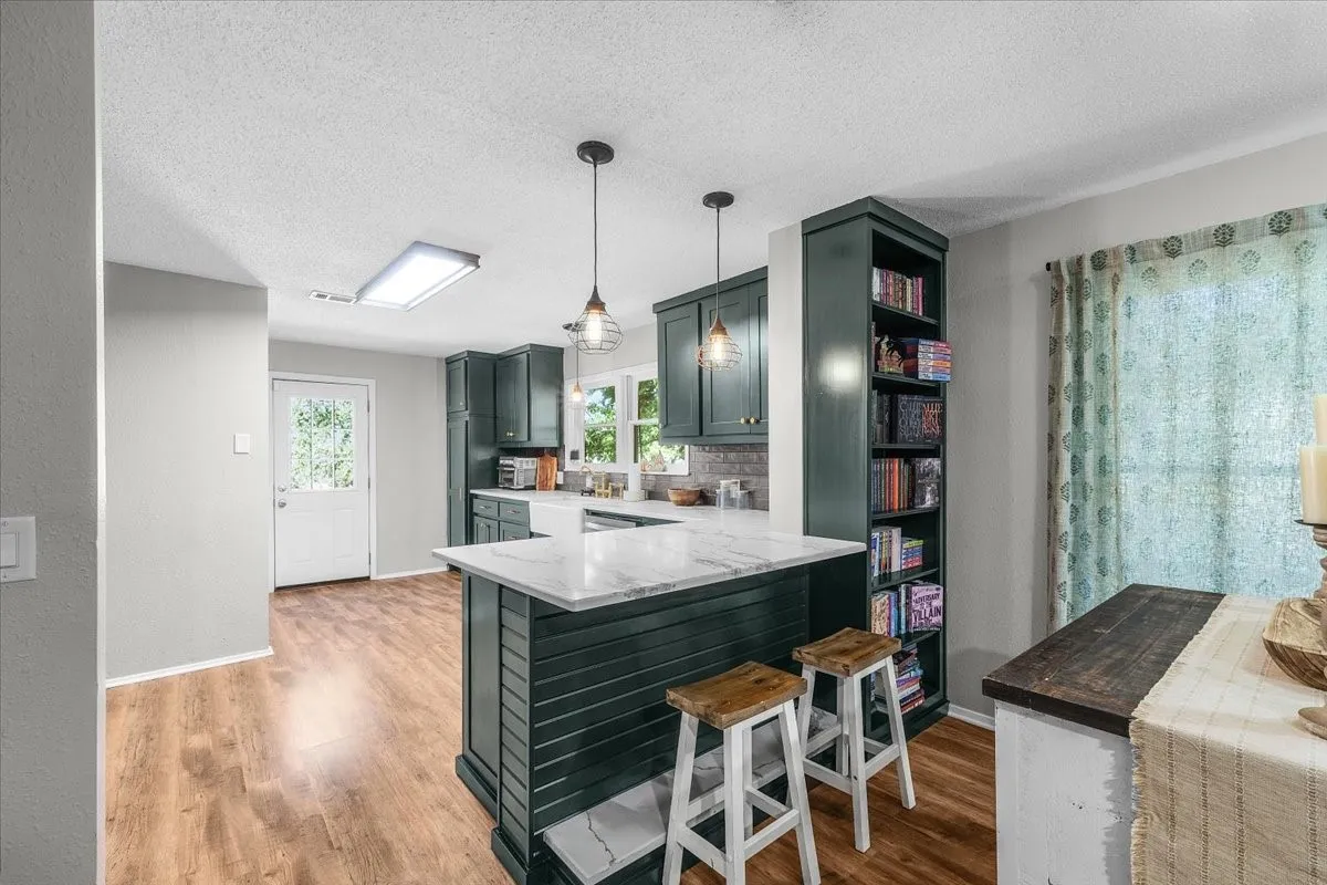 Kitchen island featuring a white granite countertop