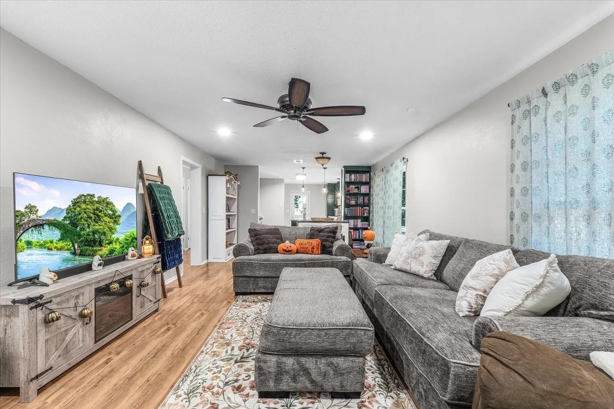 Recessed lighting, wood-finish flooring, ceiling fan, and built-in shelving