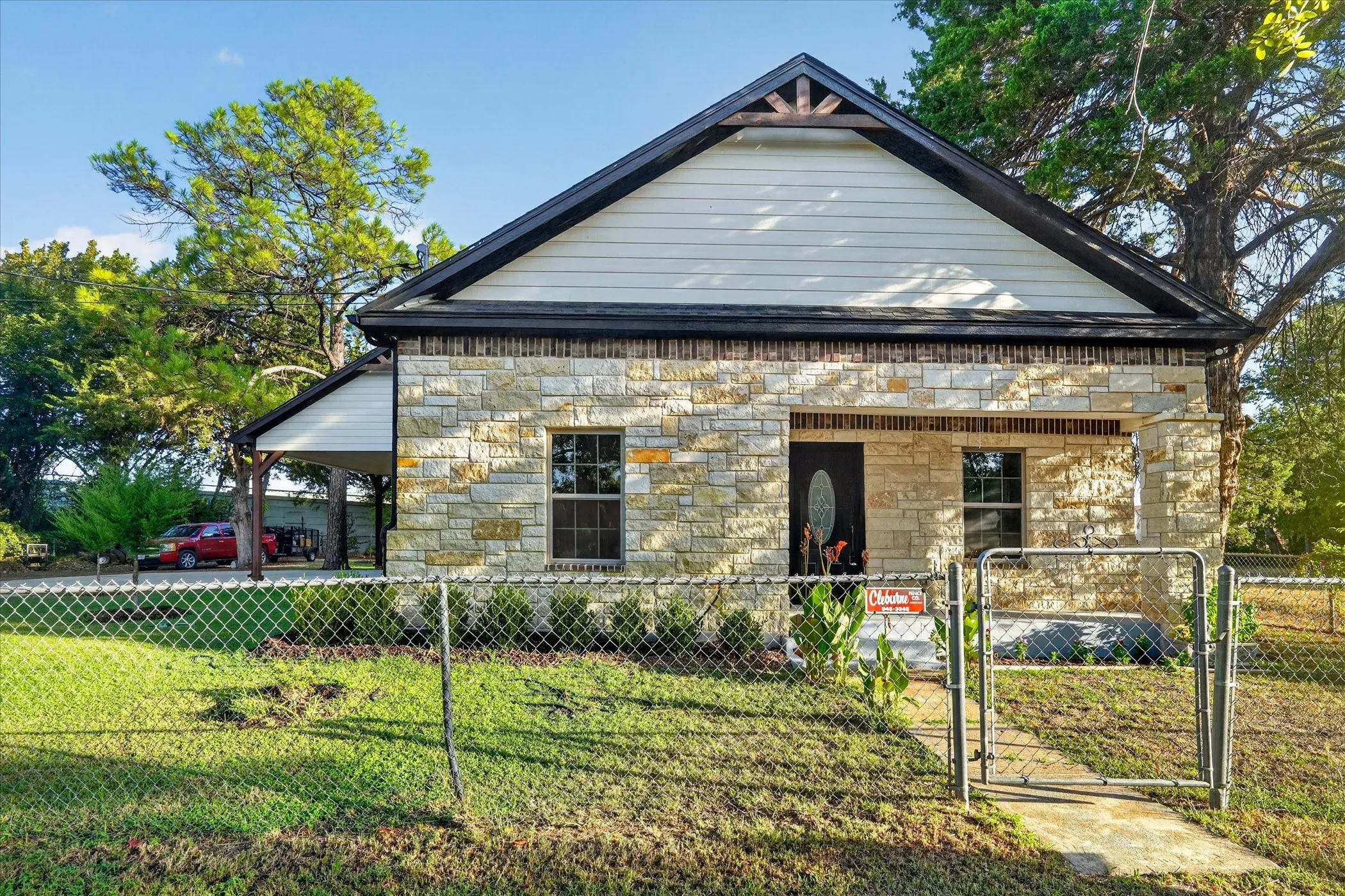 Stone and siding exterior with a covered front entry