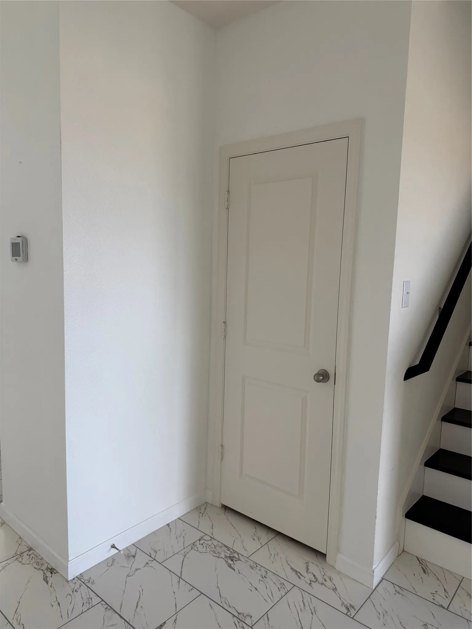 White paneled door with a polished chrome doorknob