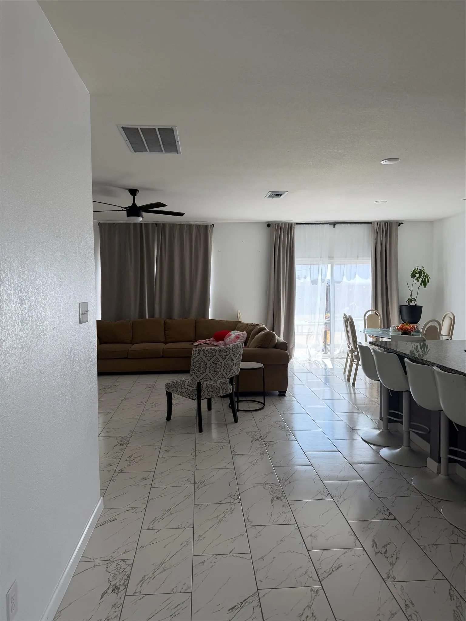 Tile flooring throughout with a ceiling fan and recessed lighting