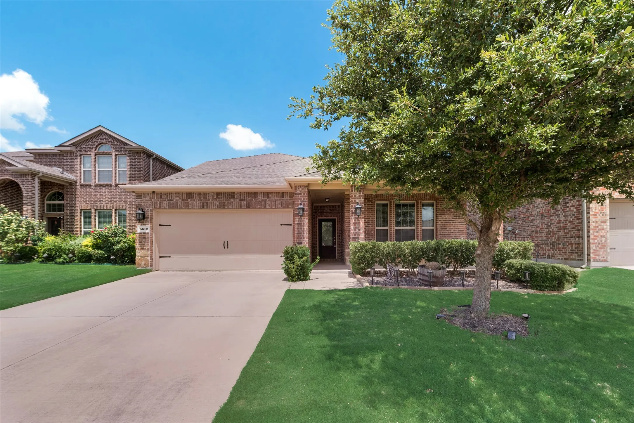 View of front of property with a garage and a front yard