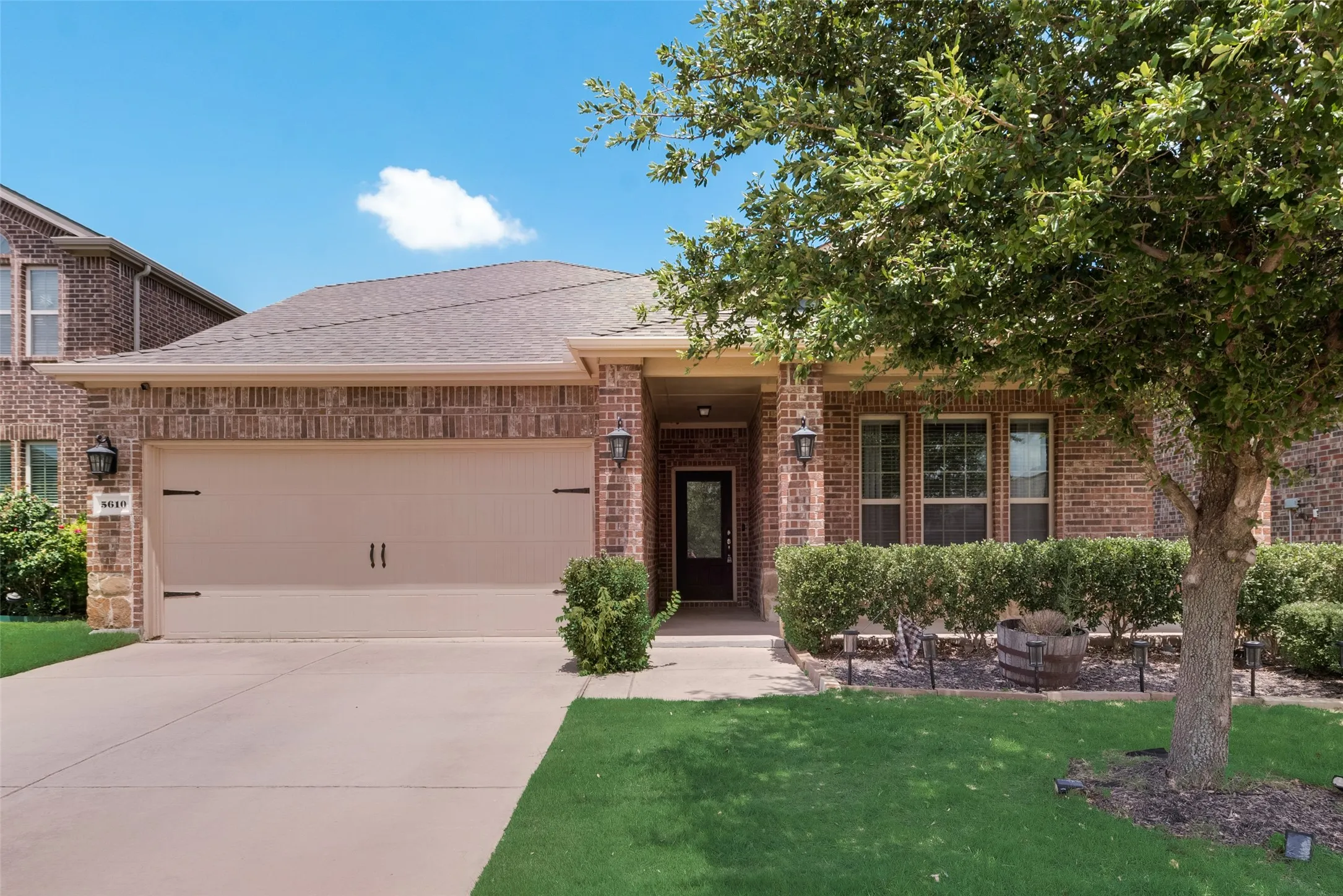 View of front of home featuring a garage and a front lawn