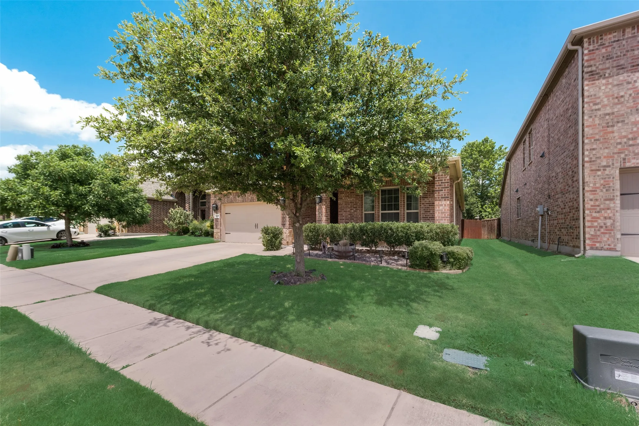 View of front of house with a garage and a front lawn