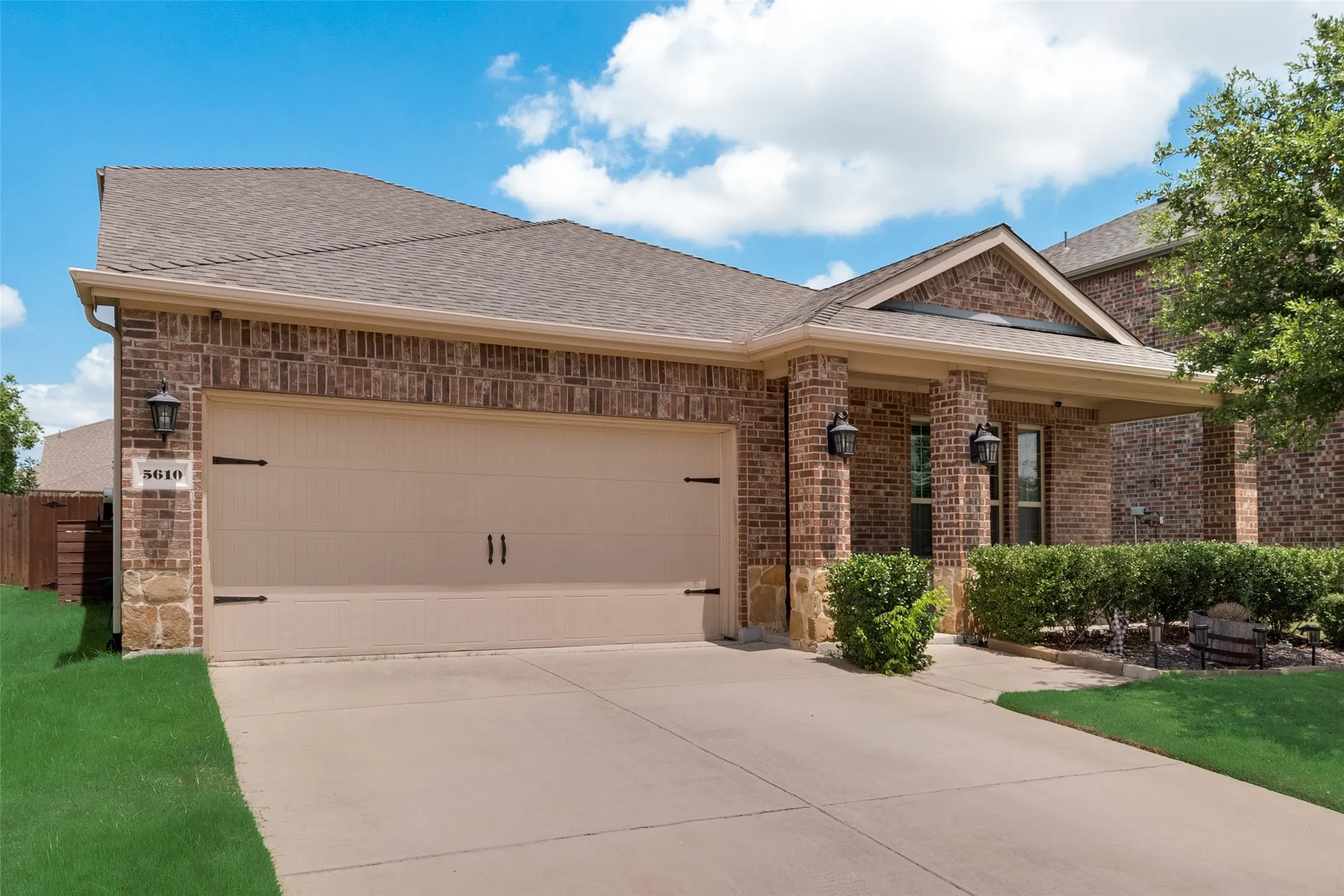View of front of house featuring a garage and a front lawn