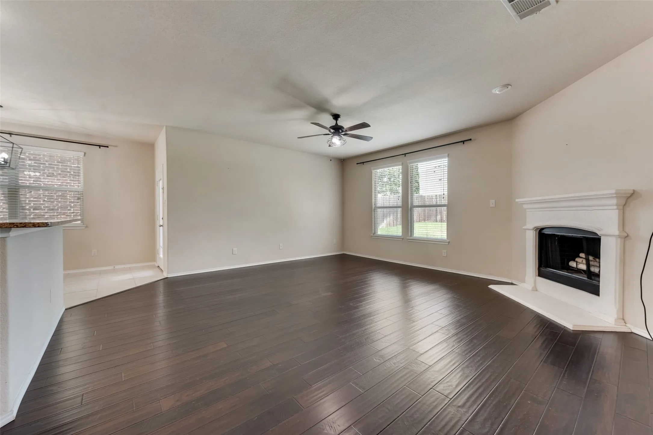 Unfurnished living room with hardwood / wood-style flooring and ceiling fan