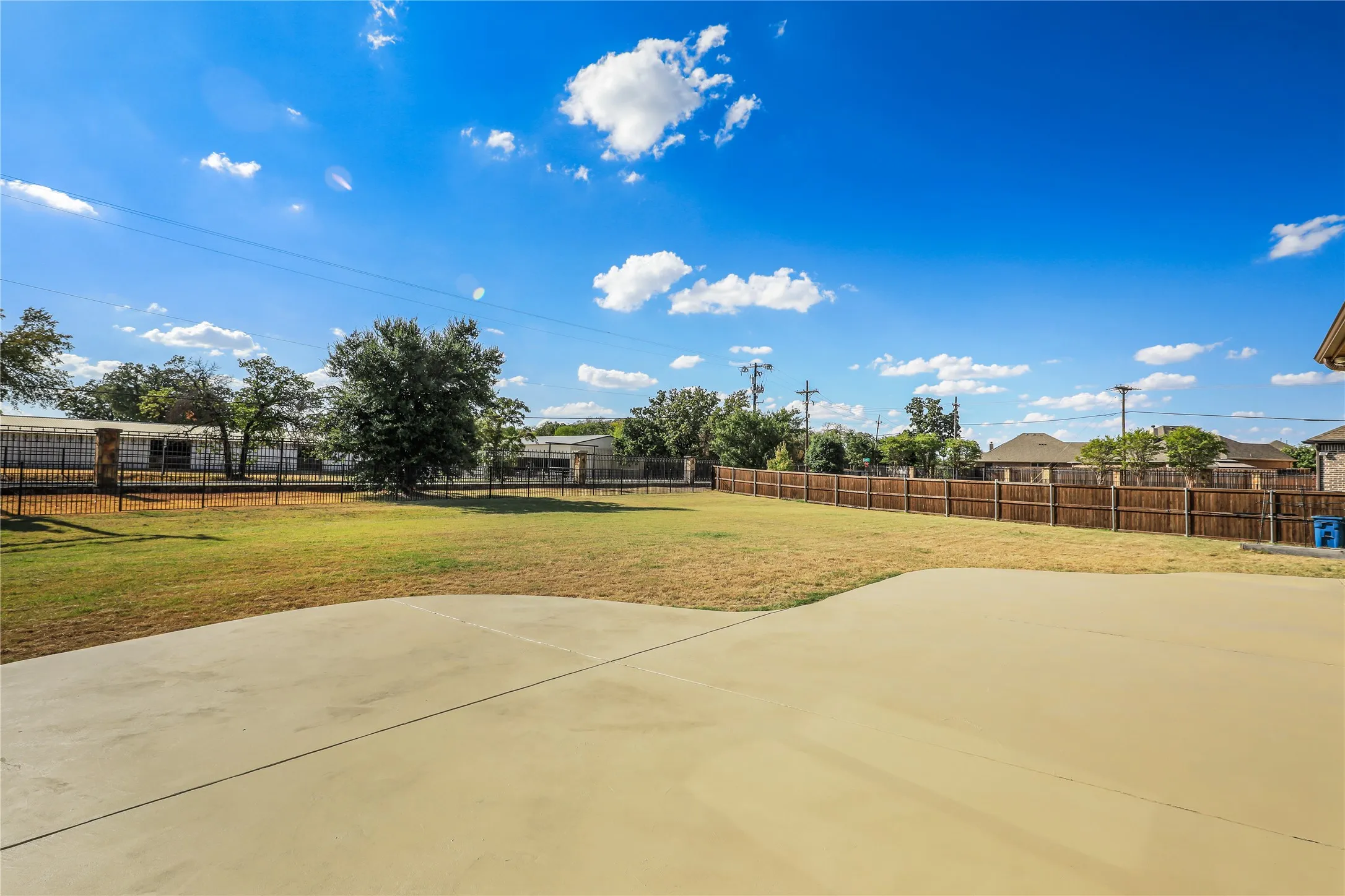 Open-concept kitchen with a large central island, contrasting dark and light cabinetry, a gas cooktop, and wood-finish flooring staging with AI