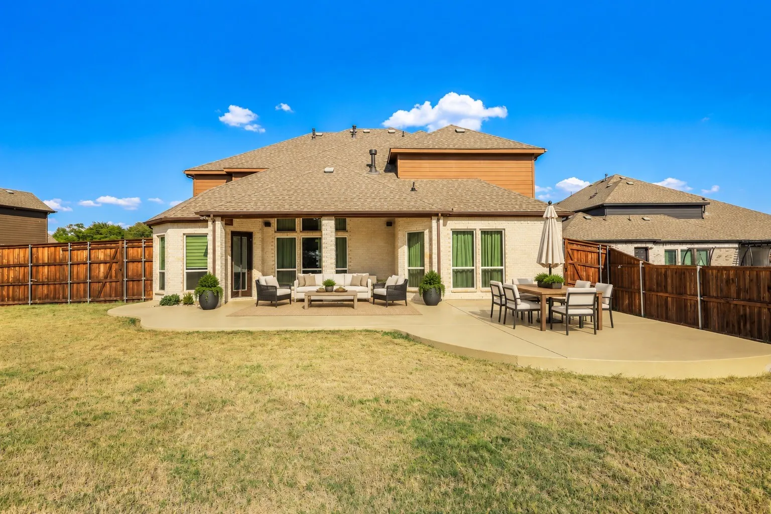 Open-concept kitchen with a large central island, contrasting dark and light cabinetry, a gas cooktop, and wood-finish flooring staging with AI