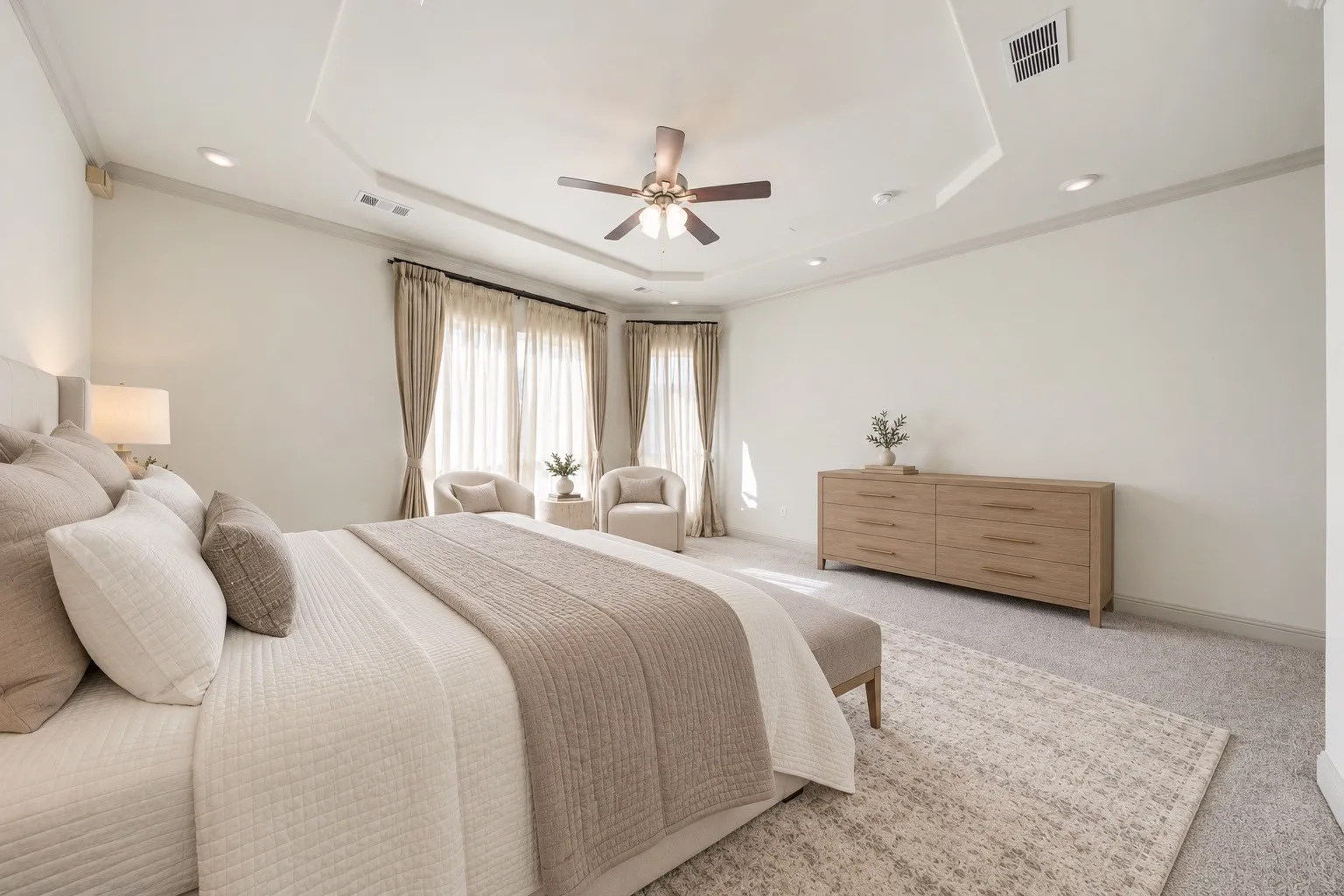 Recessed lighting and ceiling fan, tray ceiling with crown molding,  and expansive window openings-  Downstairs -staging with AI