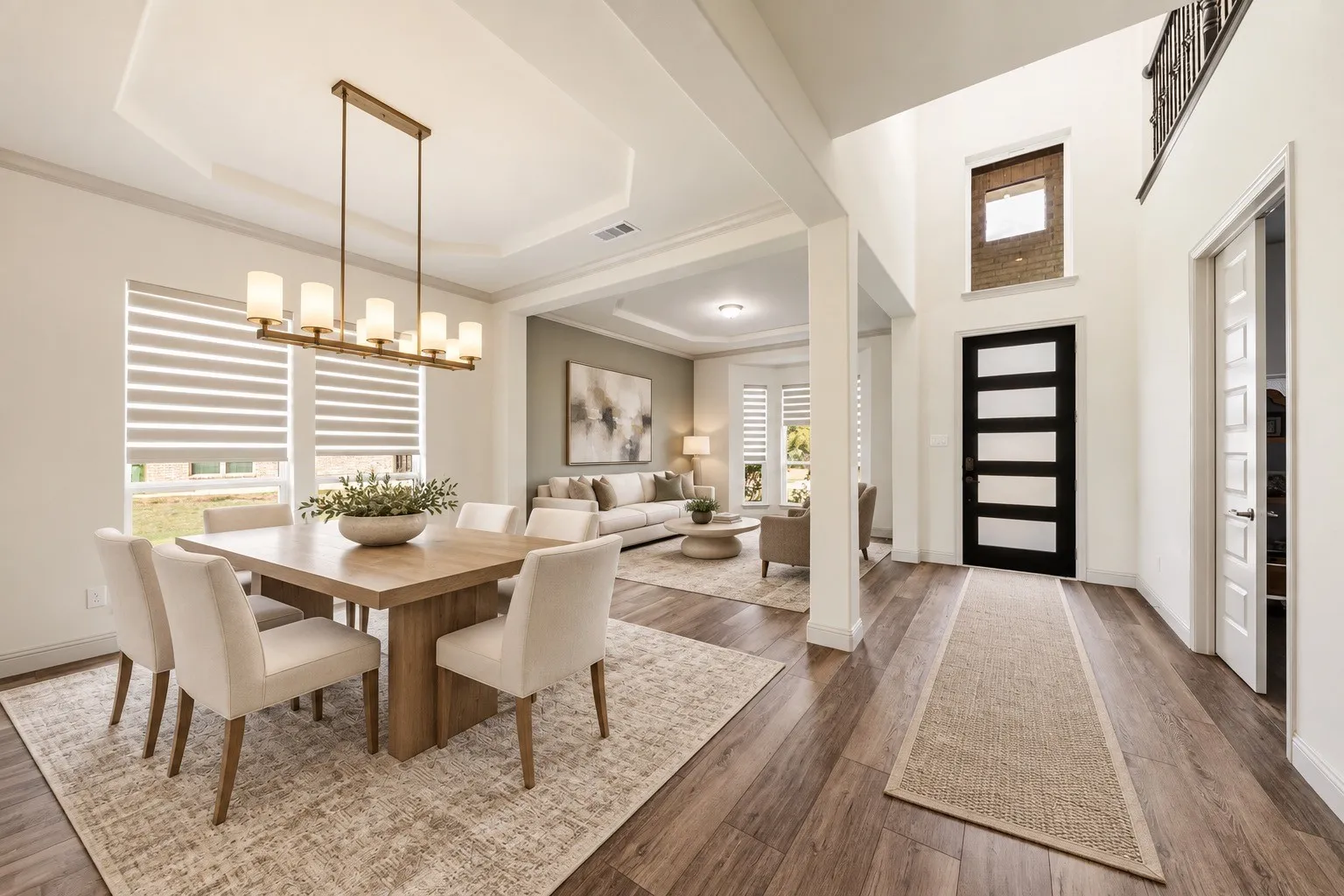 Two-story foyer with wood-finish flooring and a contemporary black door-staging with AI