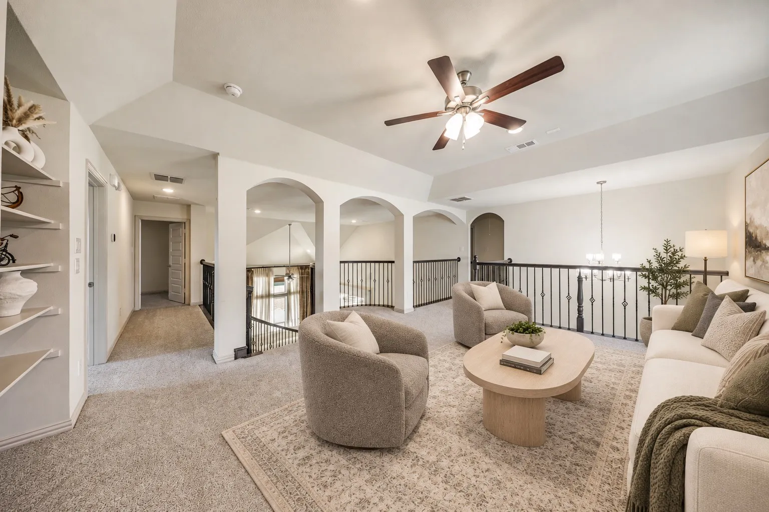 Carpeted flooring, vaulted ceiling, ceiling fan with light fixture, built-in shelving, and wrought iron railing staging with AI