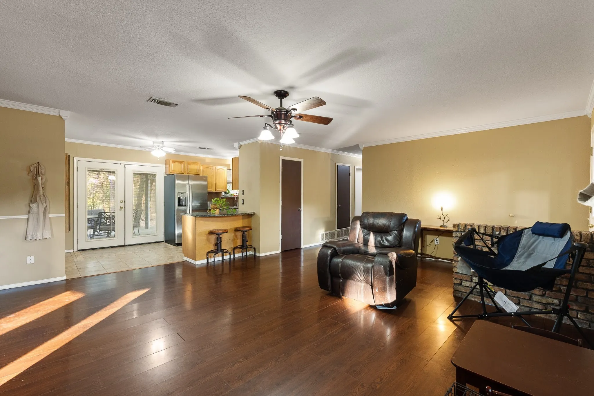 Wood-finish flooring throughout, ceiling fan with light fixture