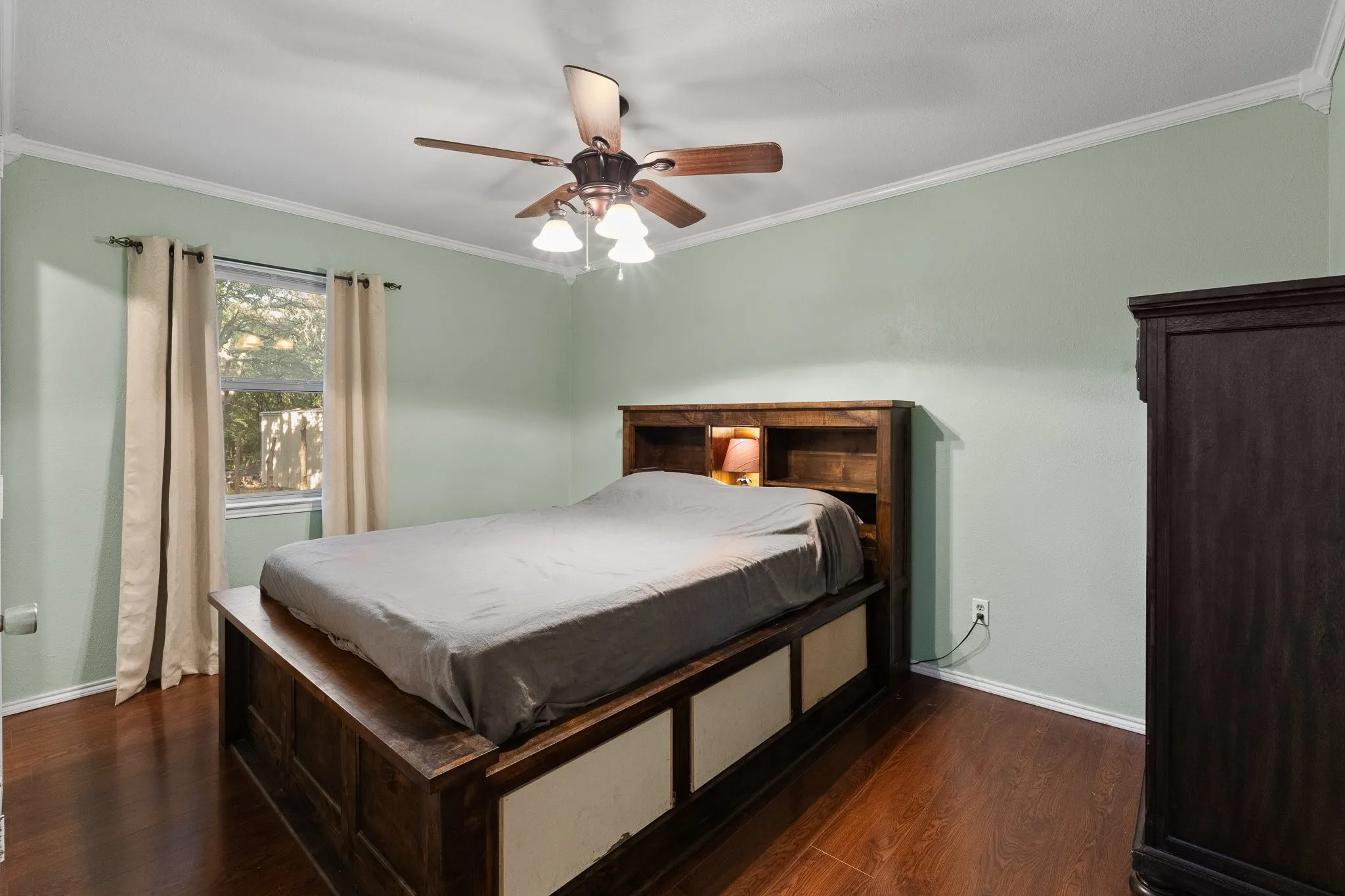 Wood-finish flooring, ceiling fan with integrated lighting, crown molding