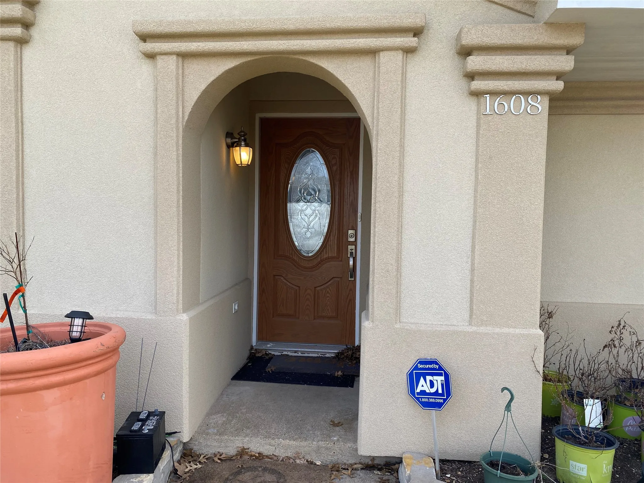 Entrance to property with stucco siding
