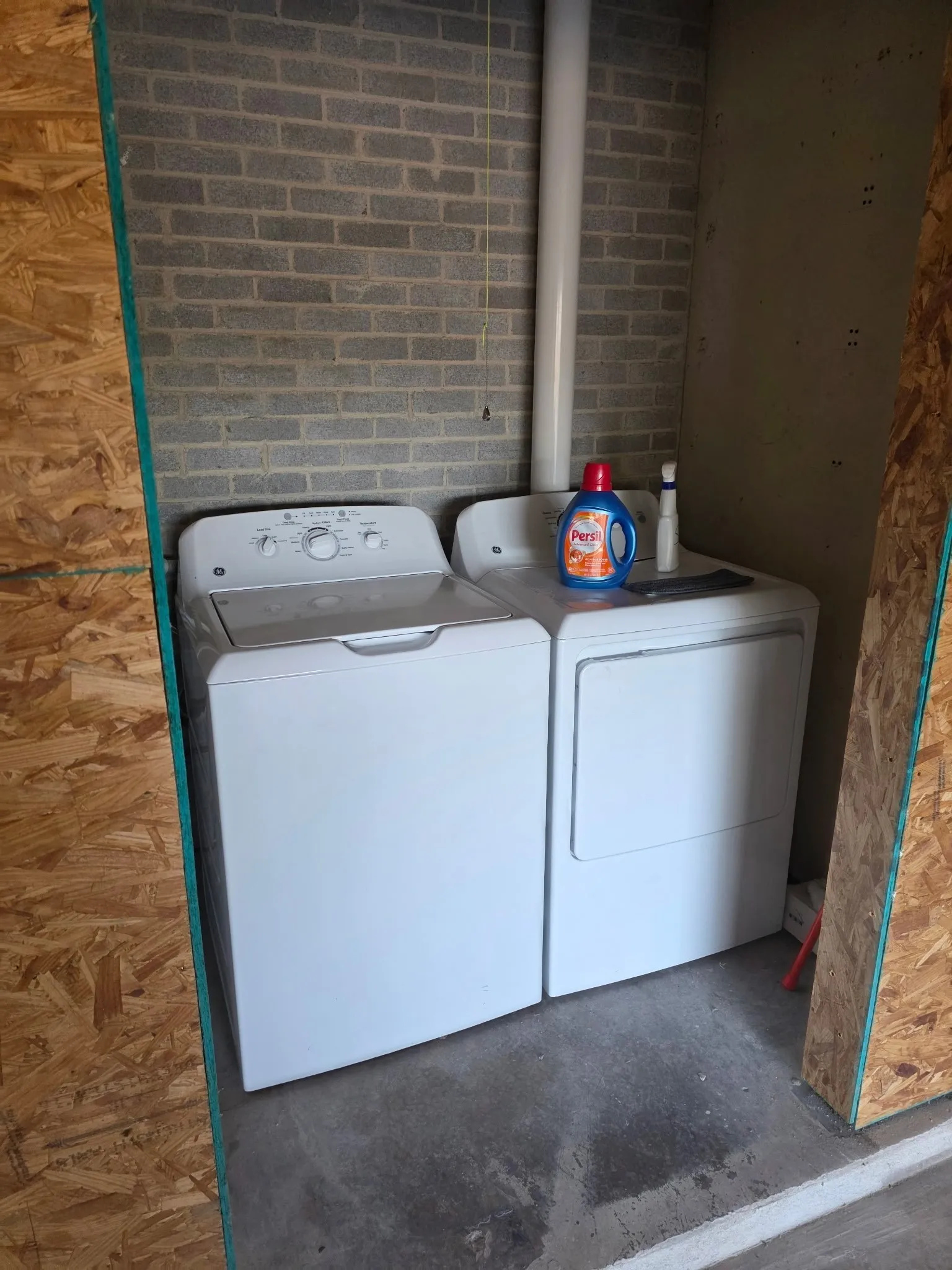 Washroom with washing machine and dryer and laundry area