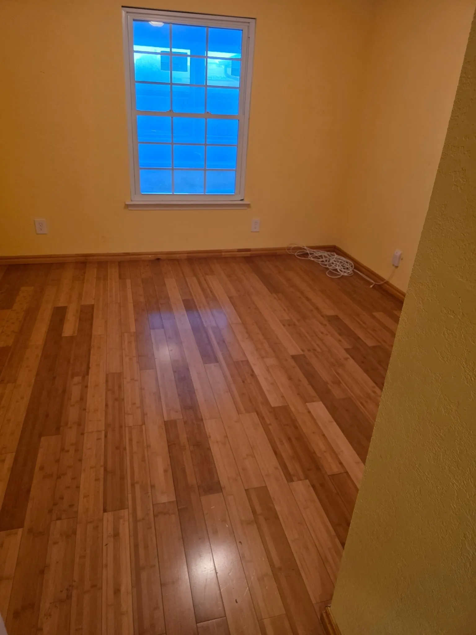 Spare room featuring baseboards and hardwood / wood-style flooring