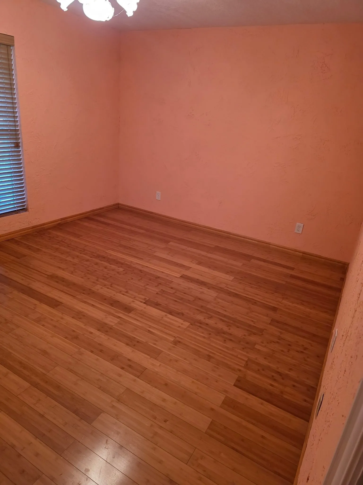 Unfurnished room featuring hardwood / wood-style floors and a chandelier