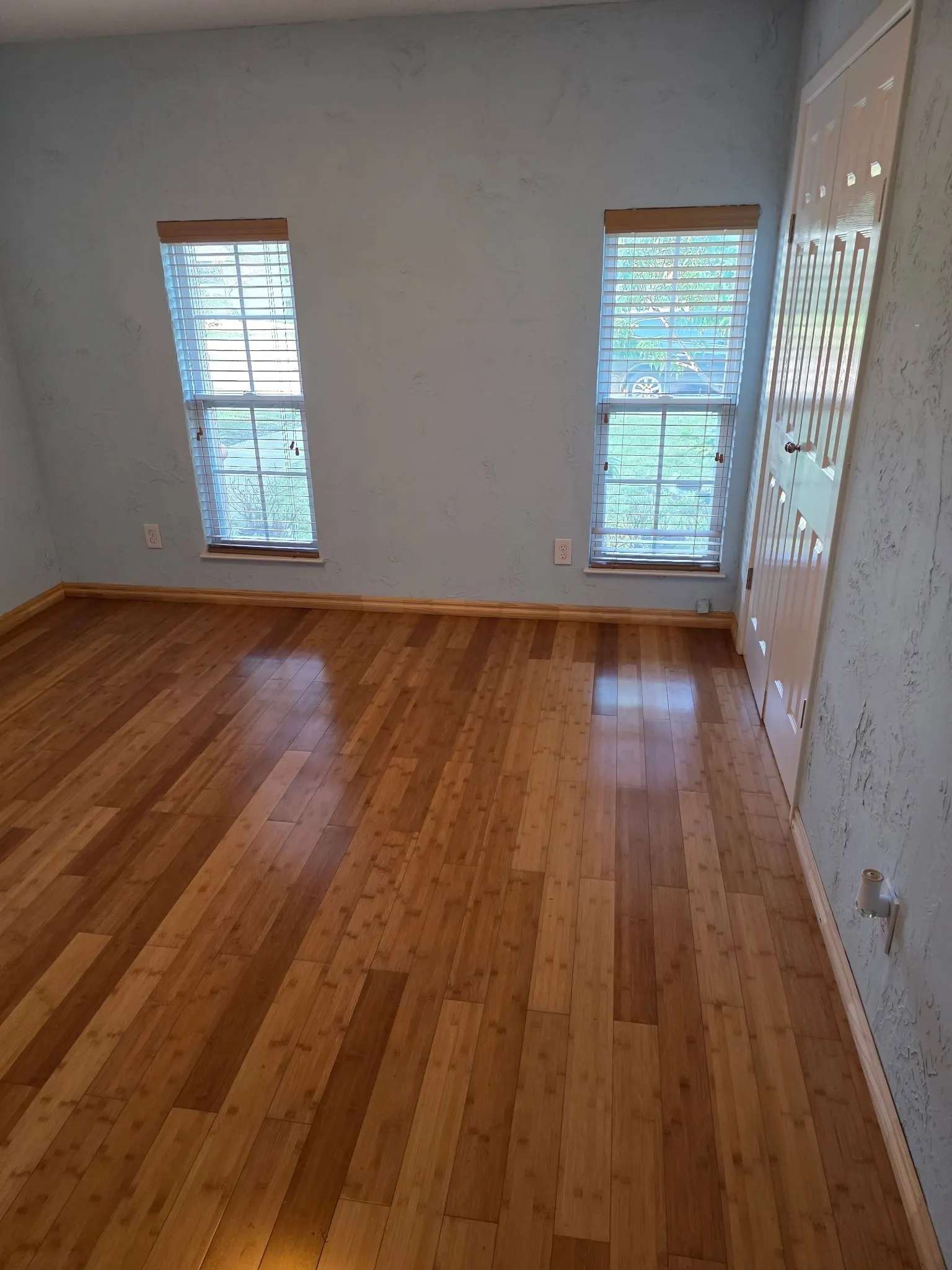 Empty room with light wood-style flooring and baseboards