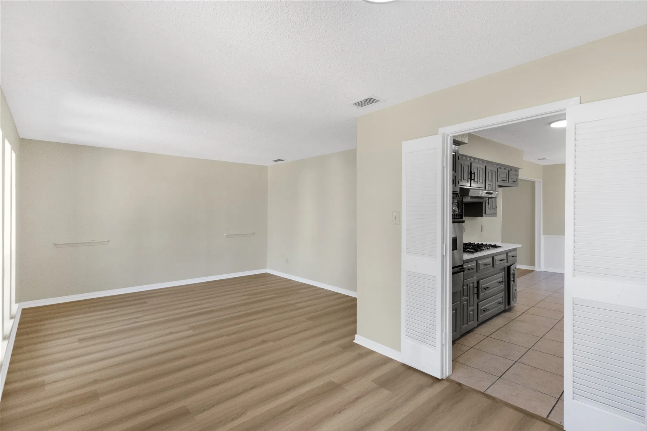 Spacious open room with wood-finish flooring