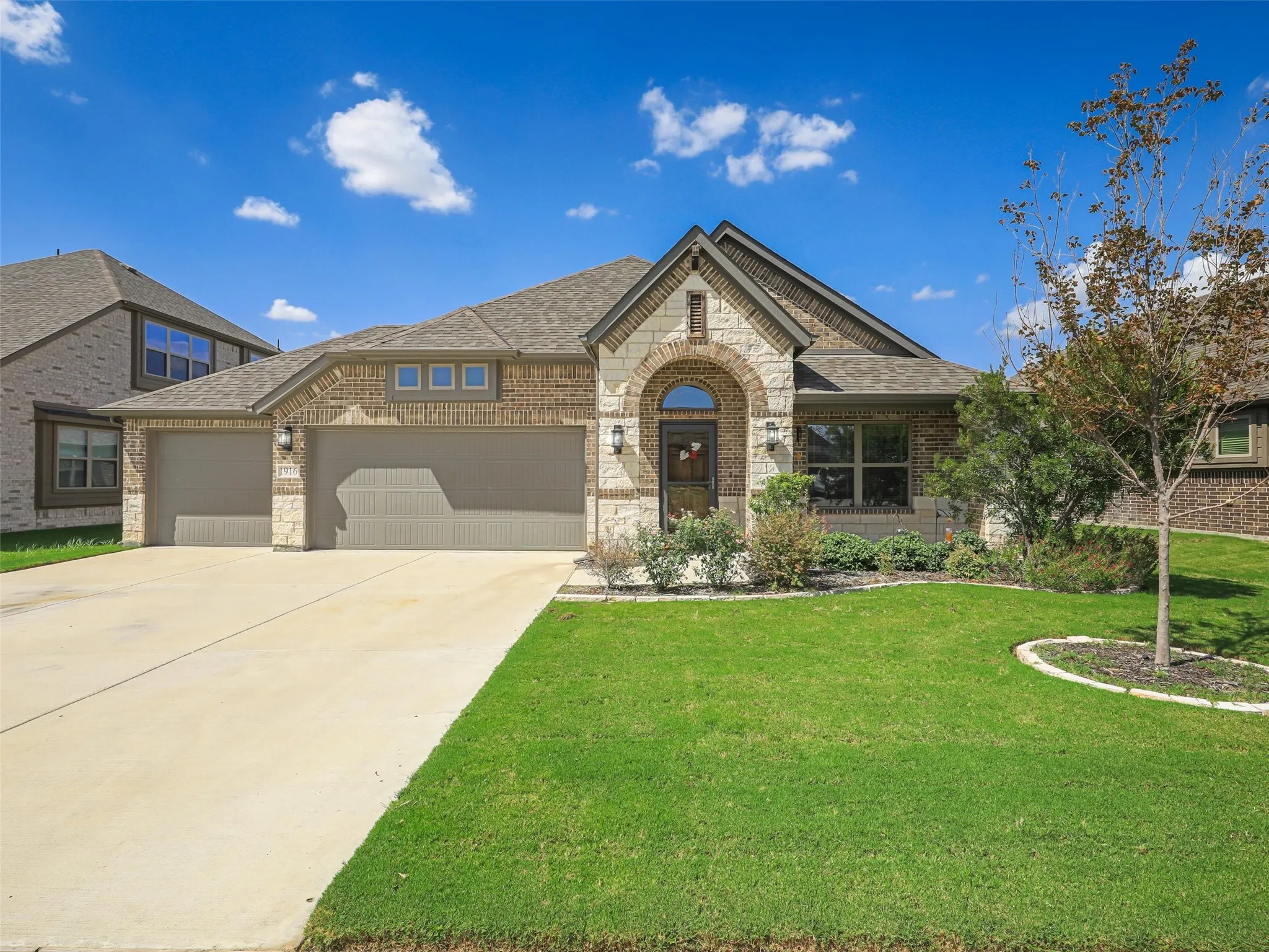 Brick and stone veneer exterior with an arched entryway