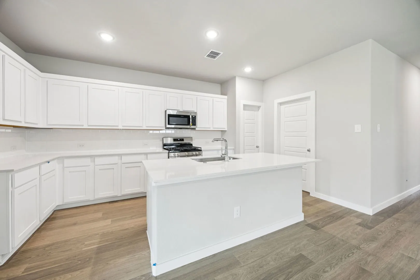 Kitchen in the Hayden home plan by Trophy Signature Homes – REPRESENTATIVE PHOTO