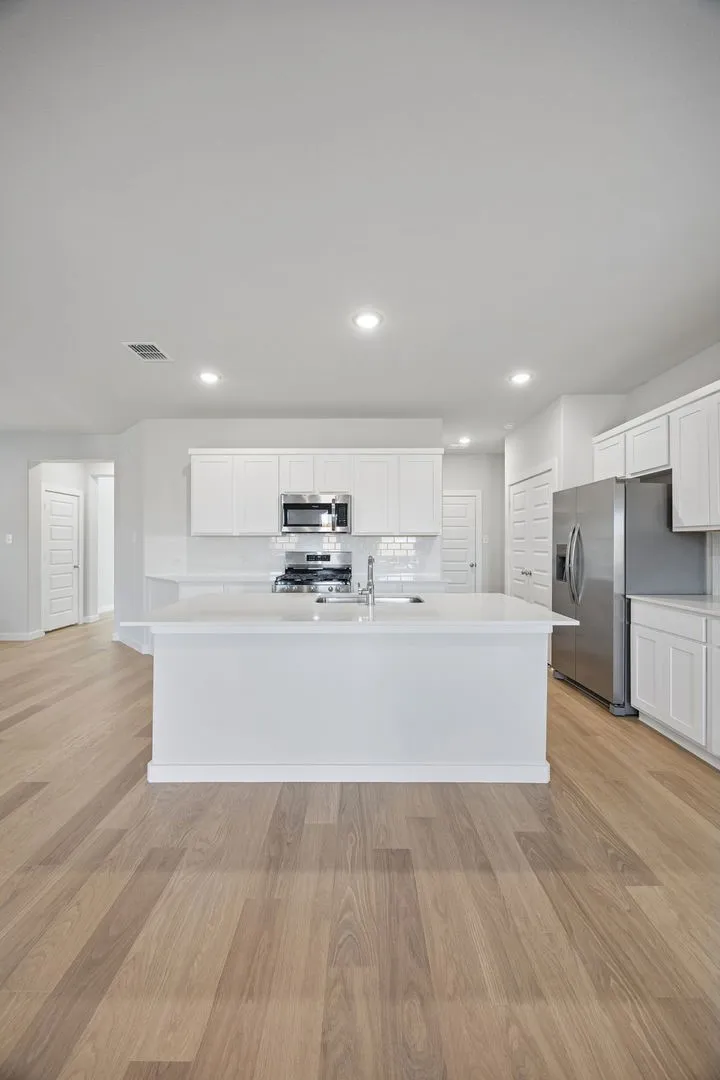Kitchen in the Oak II home plan by Trophy Signature Homes – REPRESENTATIVE PHOTO