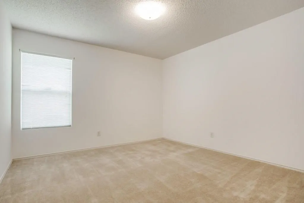 Carpeted flooring, white walls, window with blinds, flush mount ceiling light