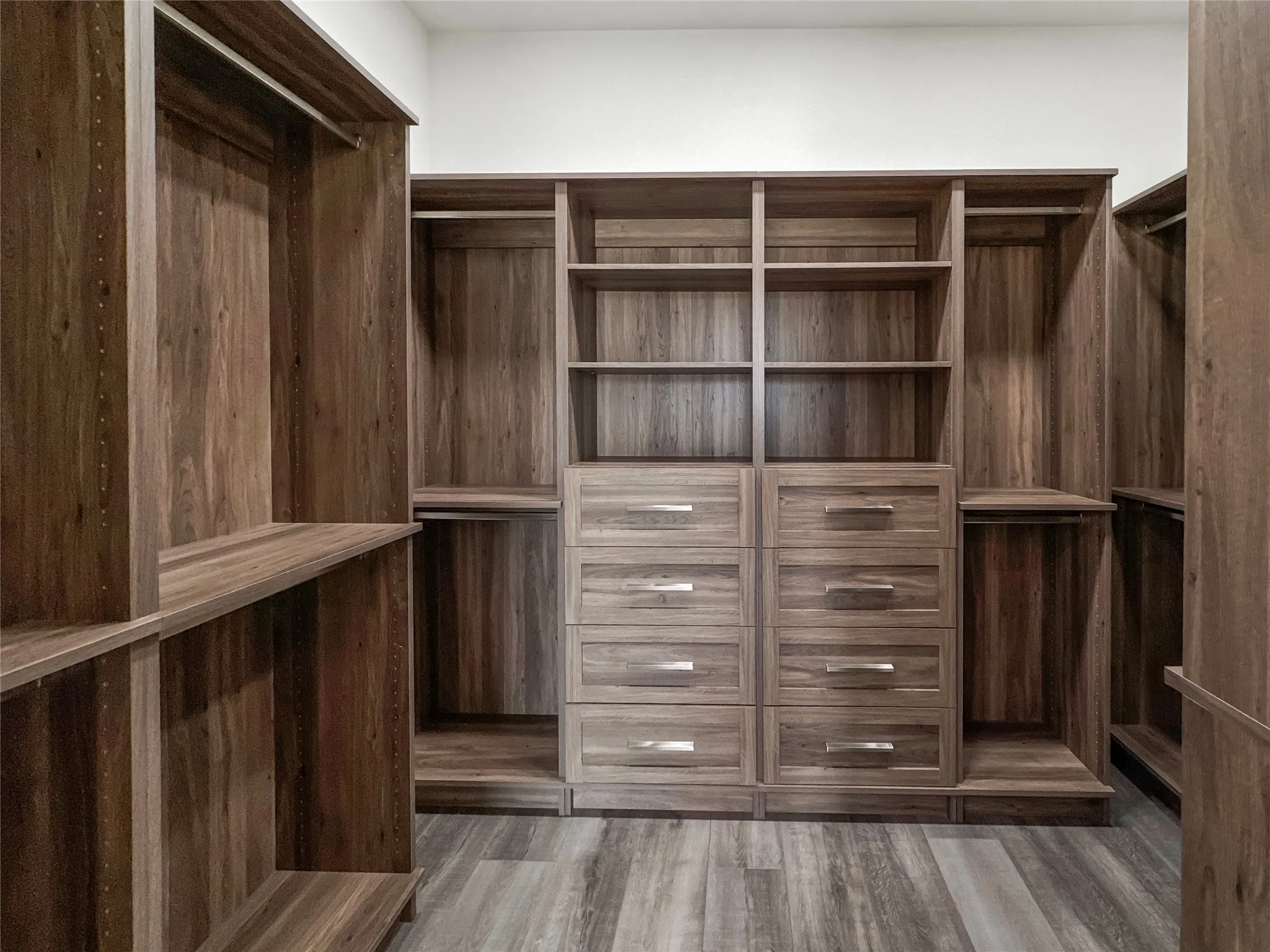 Spacious closet featuring dark hardwood / wood-style flooring
