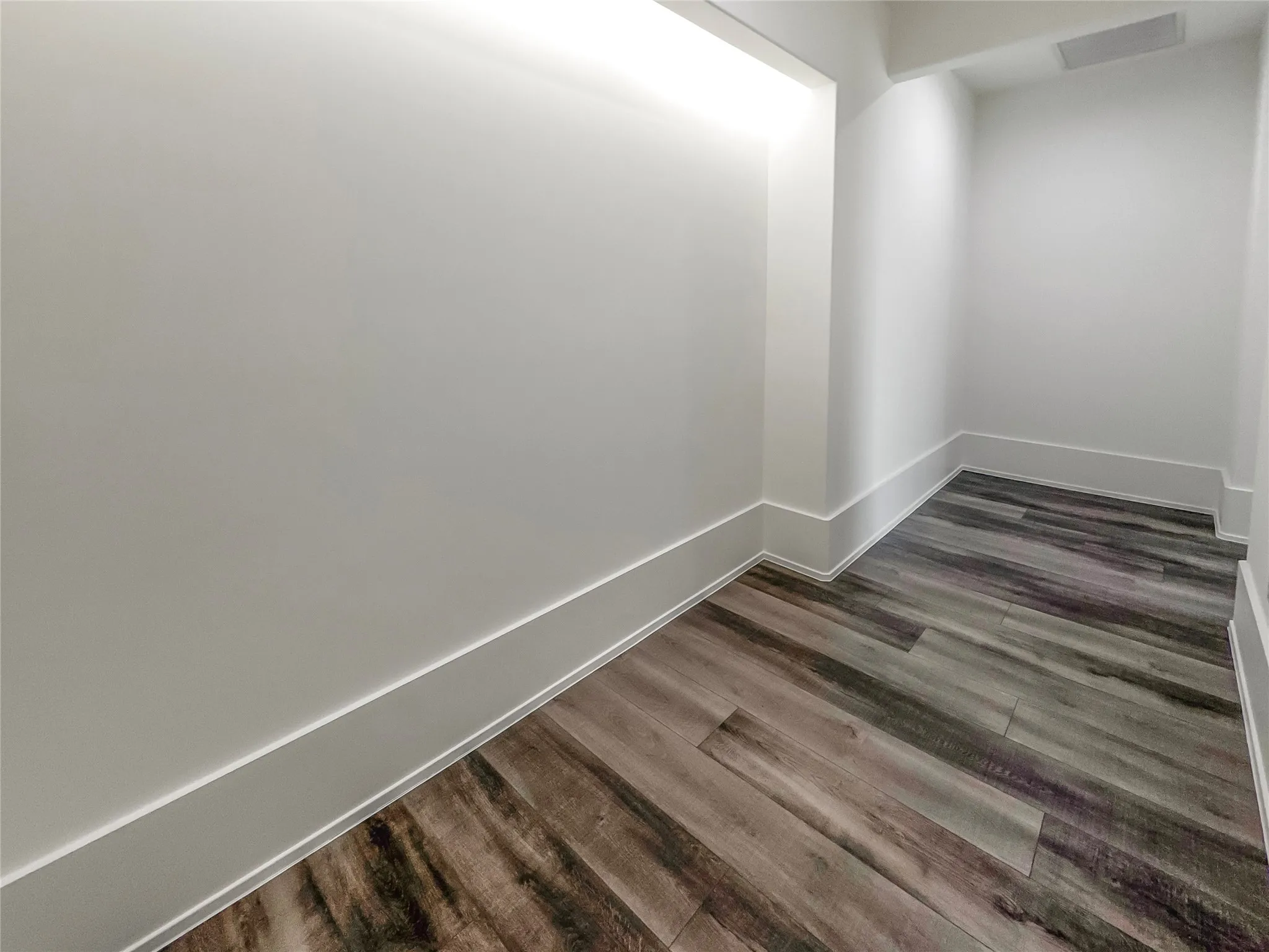 Unfurnished room featuring dark wood-type flooring