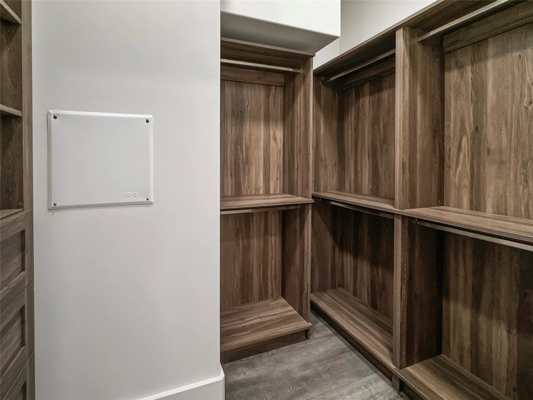 Walk in closet featuring dark hardwood / wood-style flooring
