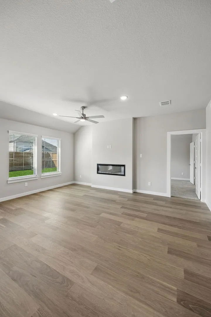 Living Room in the Emmy II home plan by Trophy Signature Homes - REPRESENTATIVE PHOTO