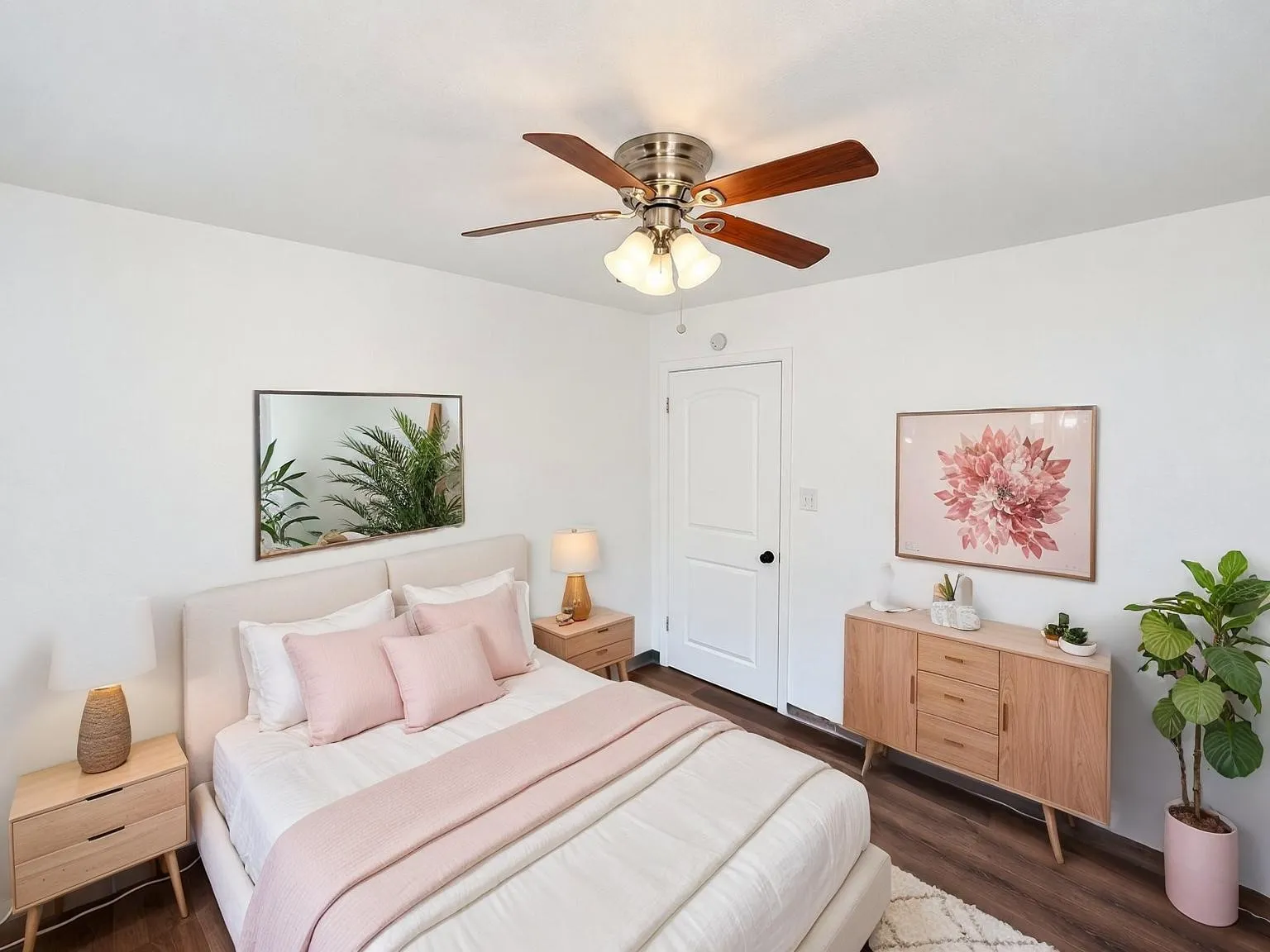 Virtually staged -
White interior walls, wood-finish flooring, ceiling fan with integrated lighting, paneled interior door, and a built-in wall mirror
