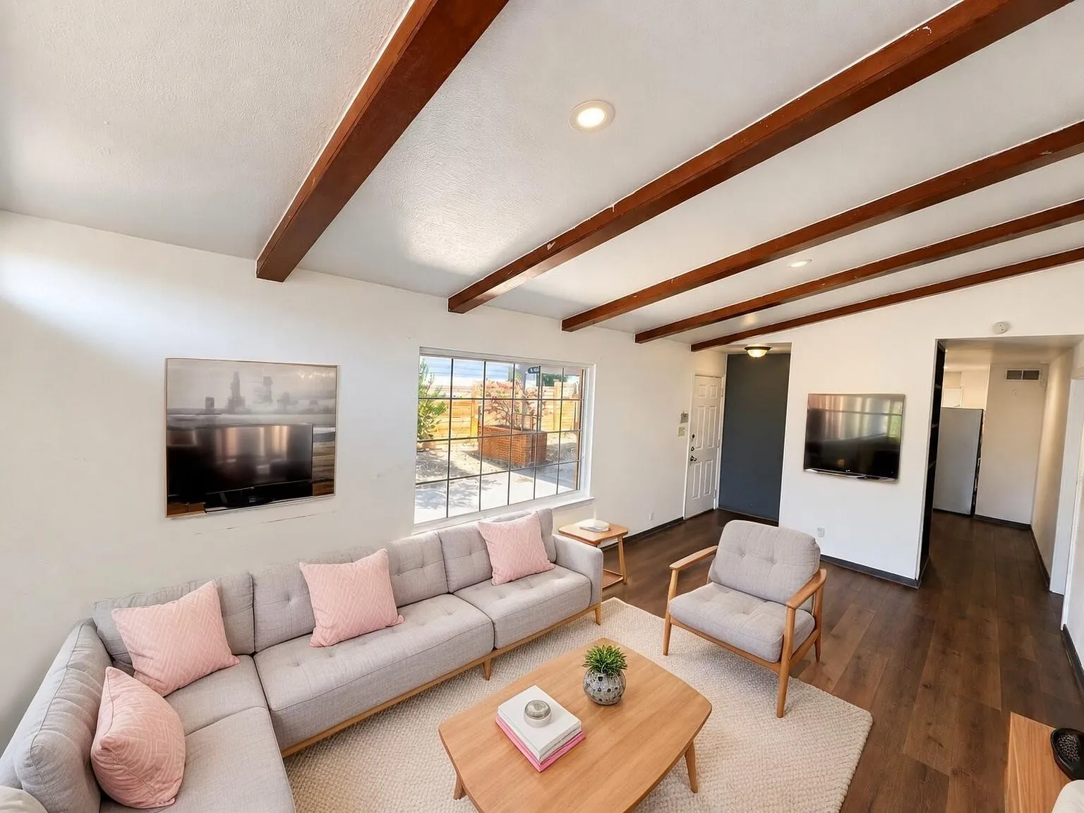 Virtually staged -
Exposed wood beams, recessed ceiling lighting, multi-pane window, wood-finish flooring, and a neutral color palette create a bright, inviting interior