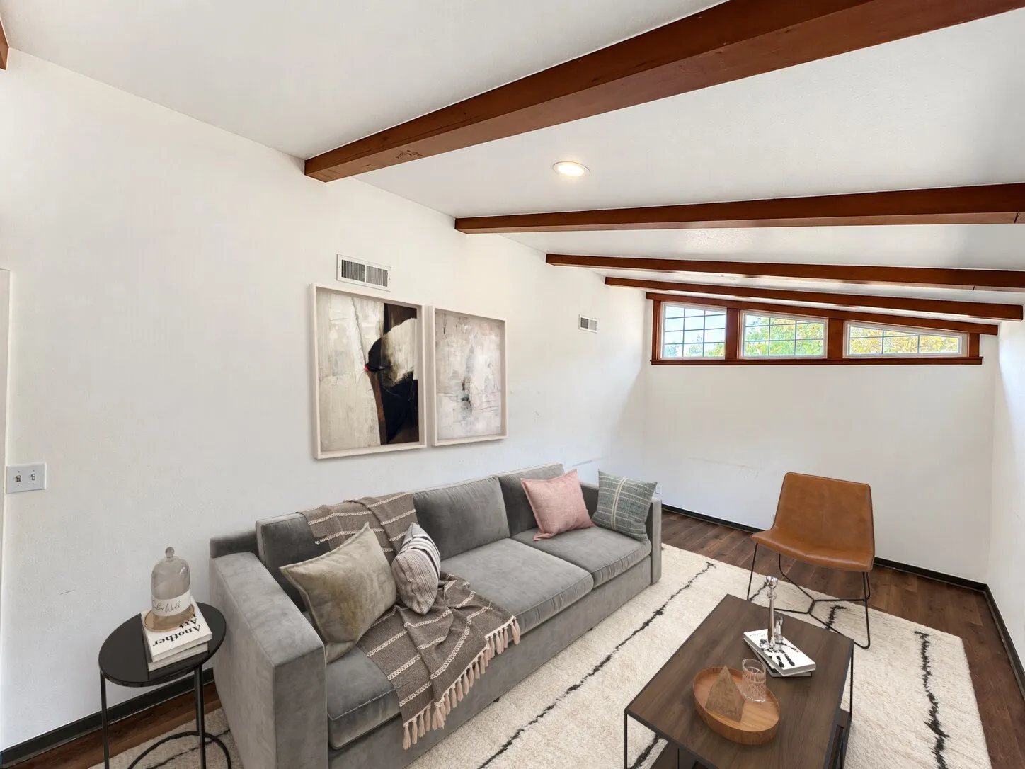 Virtually staged -
Vaulted ceiling with exposed wood beams, wood-finish flooring, recessed lighting, and a series of high windows
