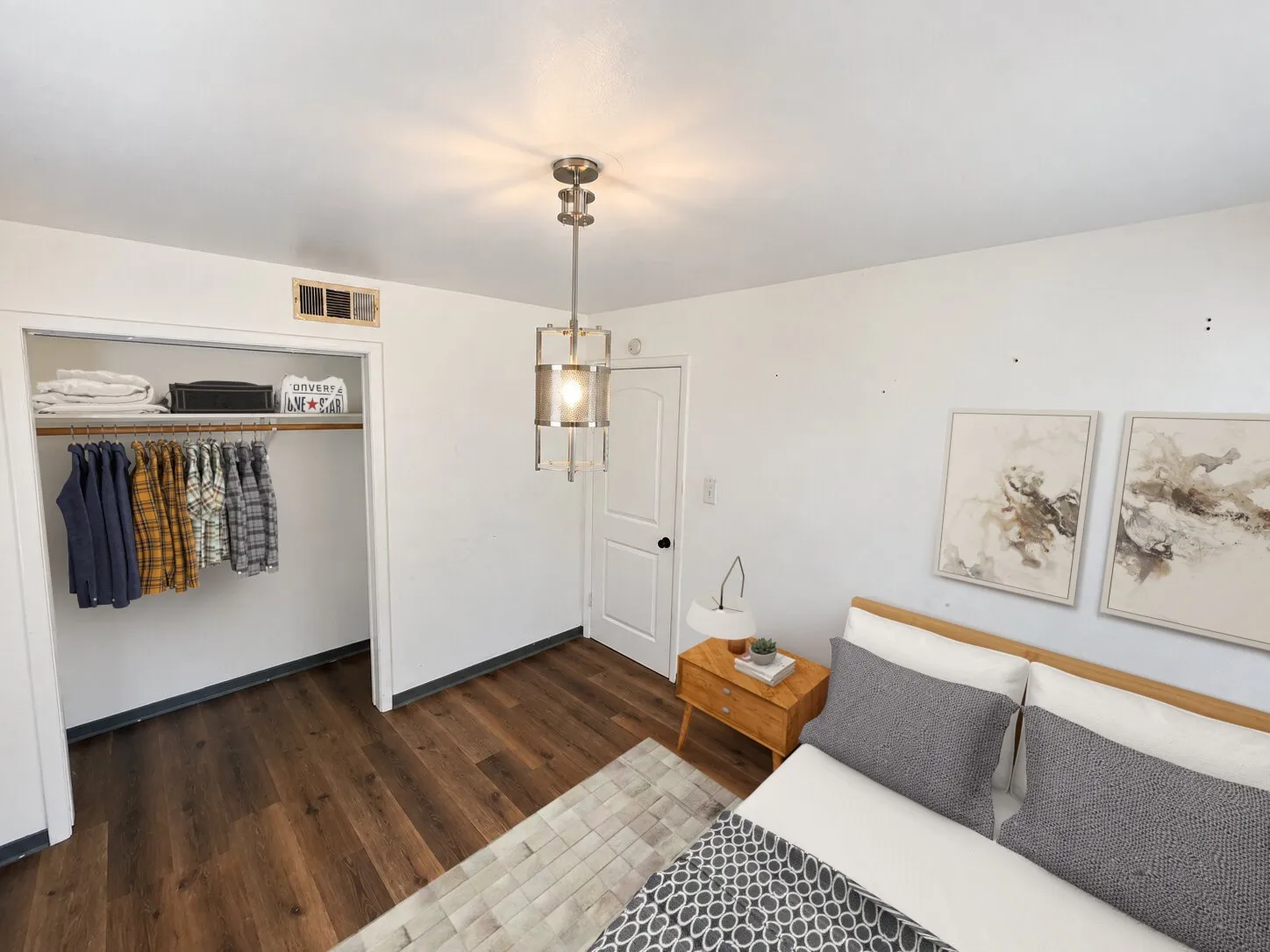 Virtually staged -
Wood-finish flooring, recessed closet with shelving, ceiling-mounted light fixture, white interior door with black hardware