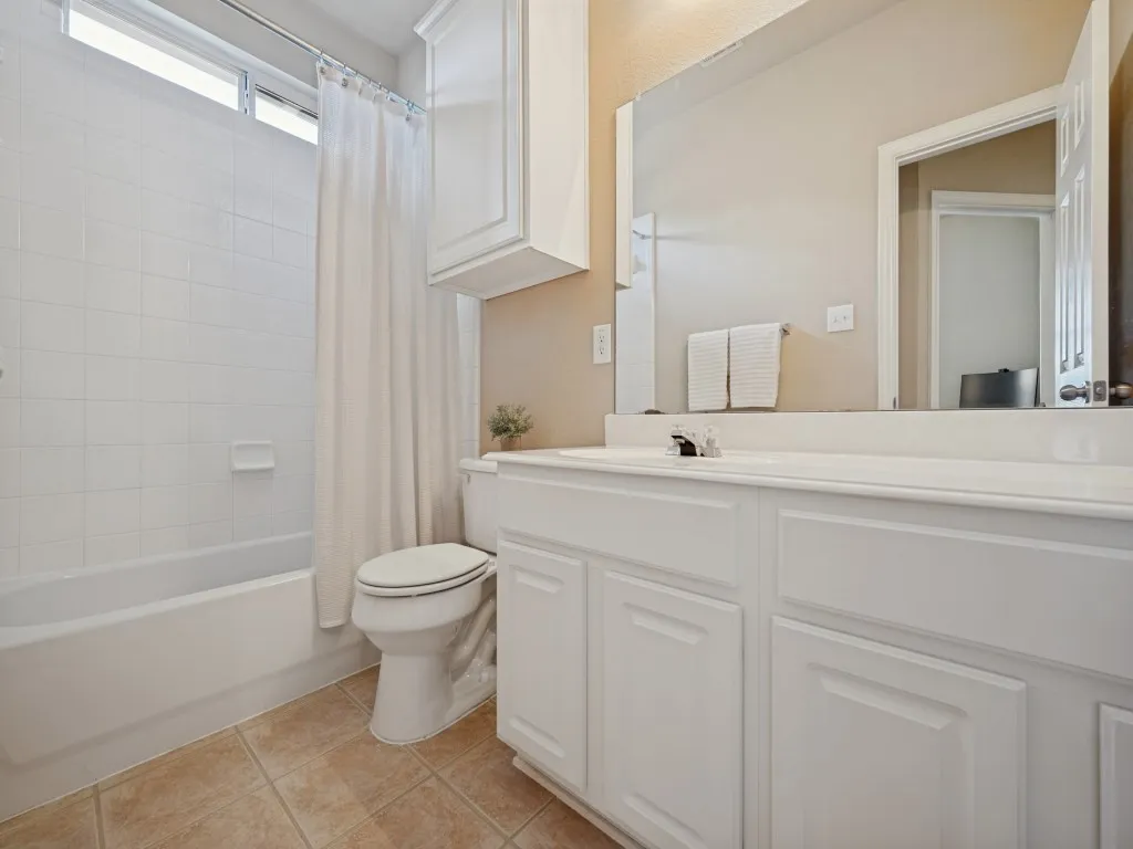 The well-appointed secondary bath features a tub and shower combination, providing both comfort and functionality for family and guests.