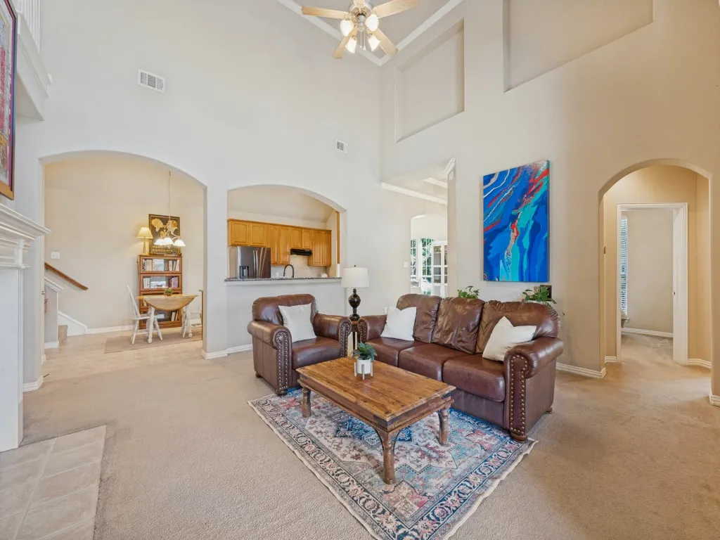 Soaring ceilings create a grand, open feel in the living room, adding to the home’s spacious and inviting atmosphere.