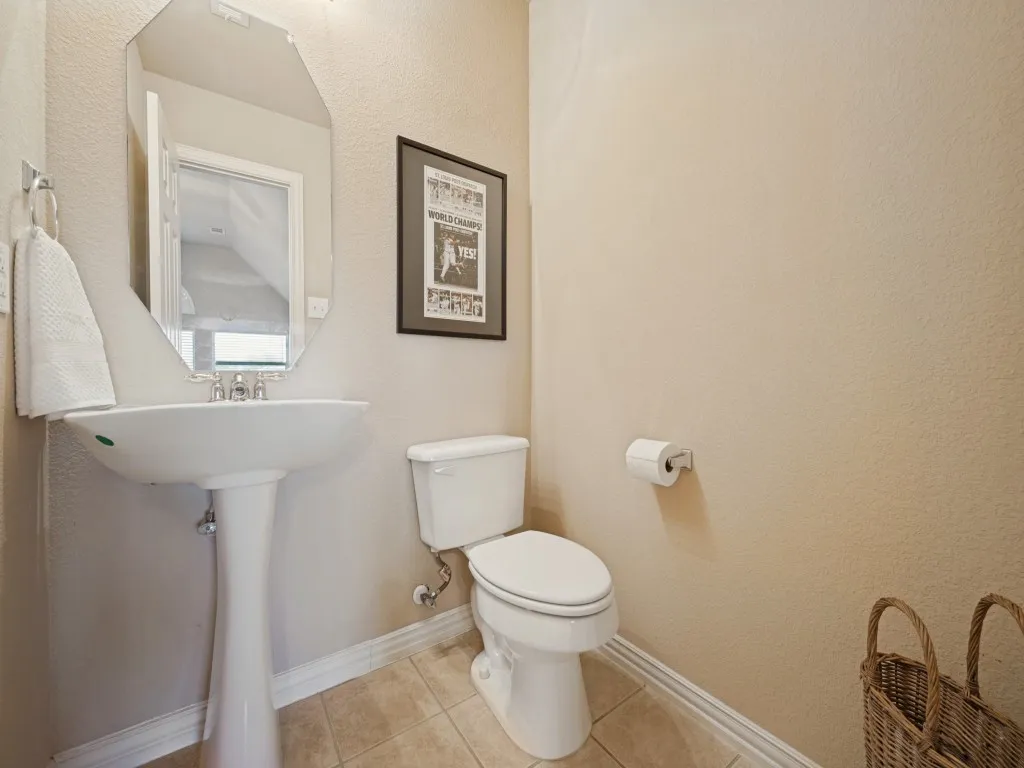 Conveniently located near the upstairs game room, the half bath provides easy access for family and guests while enjoying the second-floor living space.