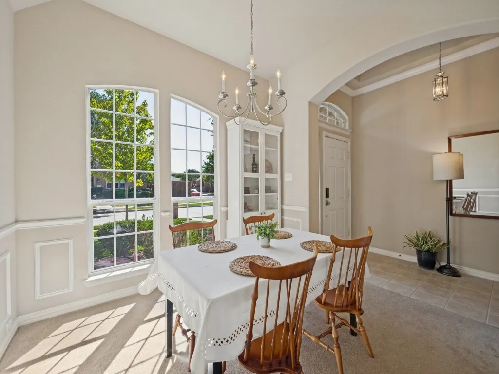 The inviting dining room is thoughtfully positioned off the front entry and features windows that fill the space with natural light, creating a welcoming setting for meals and entertaining.