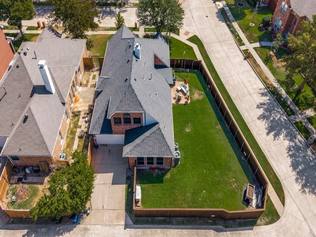An aerial view highlights the impressive oversized corner lot, showcasing the home’s generous footprint, spacious backyard, and desirable corner-lot setting.