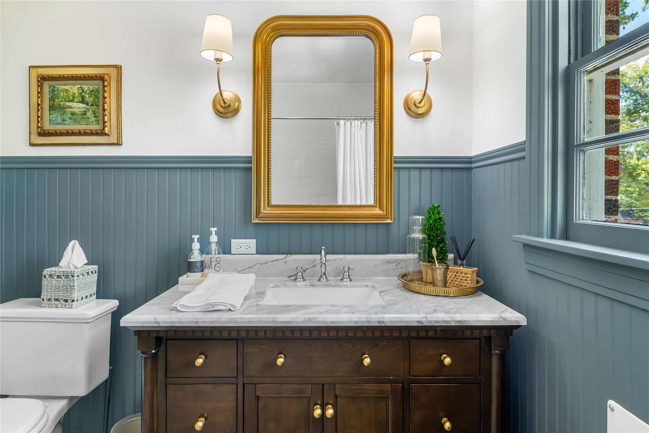 Dark wood vanity with a white rectangular sink and marble countertop