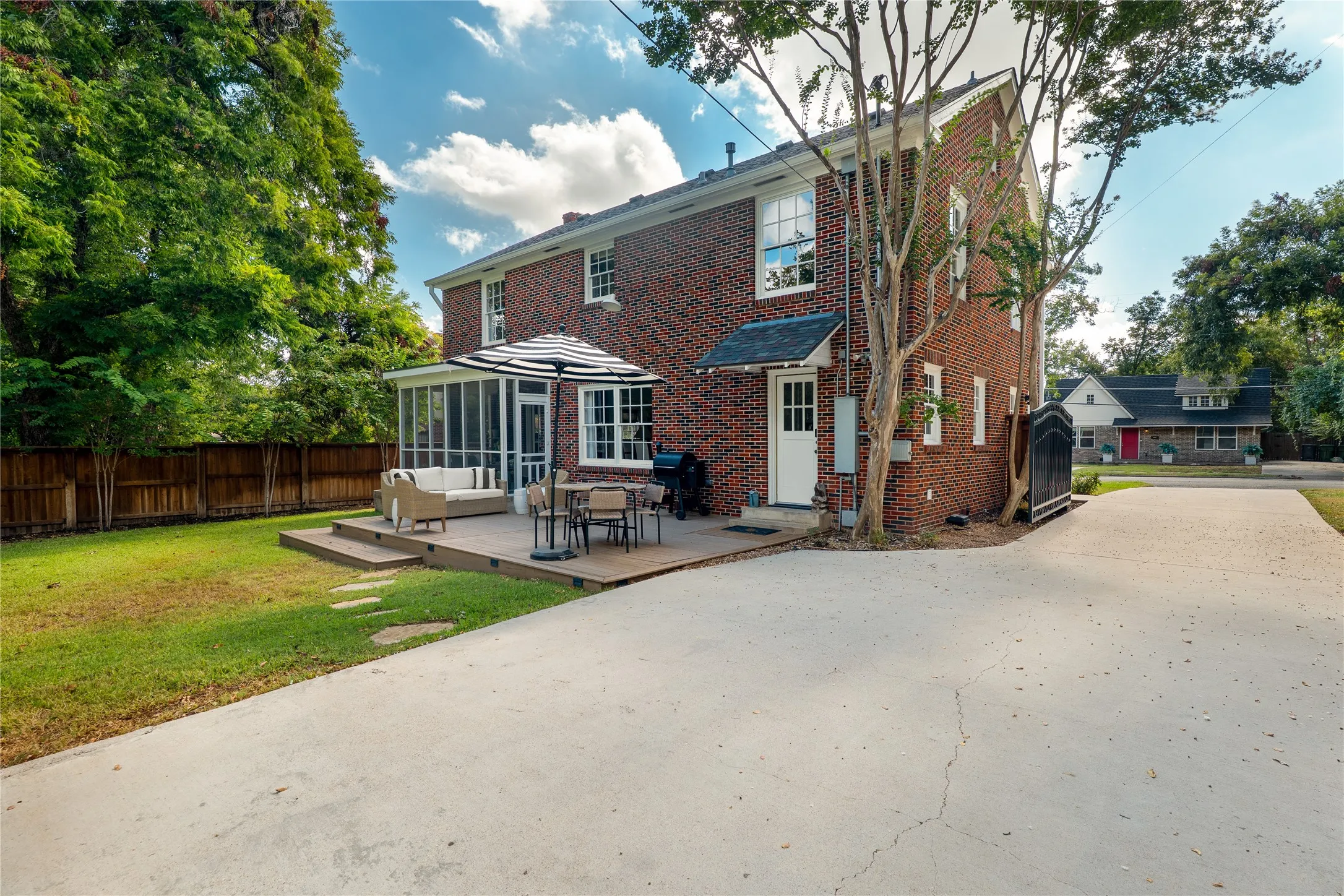 Brick exterior with white trim windows and a screened-in porch