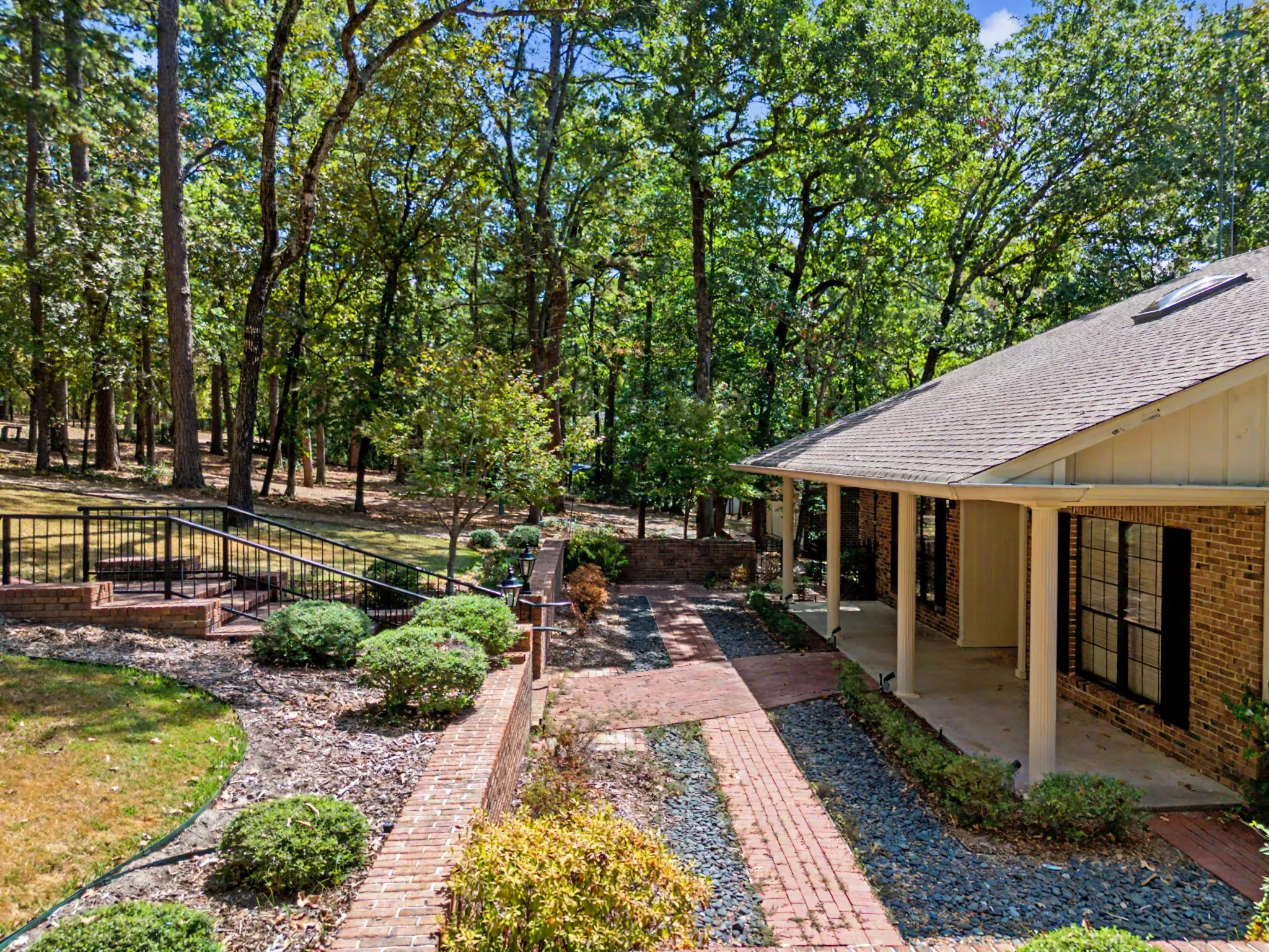 Brick retaining wall in front adds privacy when relaxing on the convered front porch