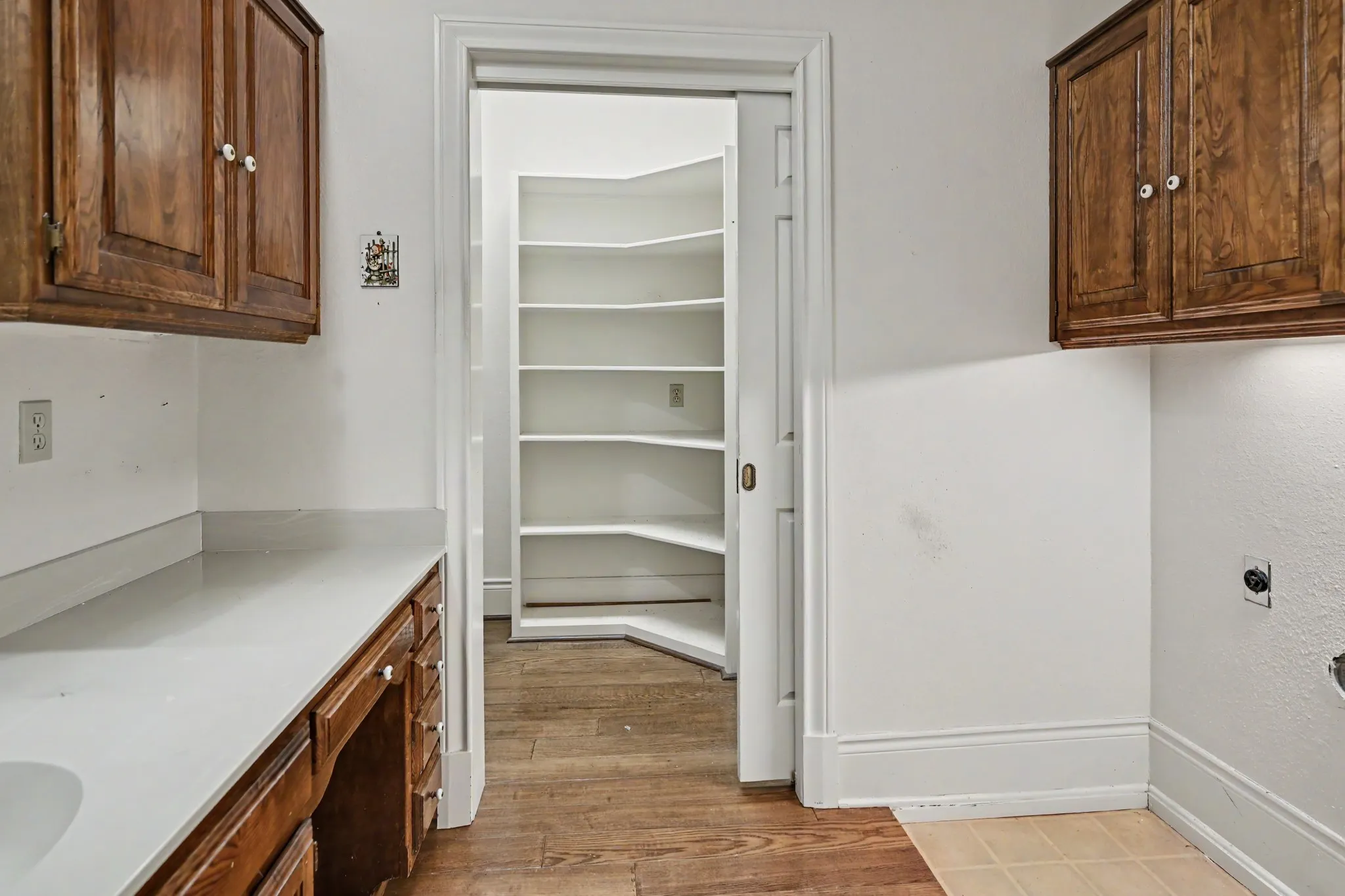 Laundry room has a sink, desk and cabinets