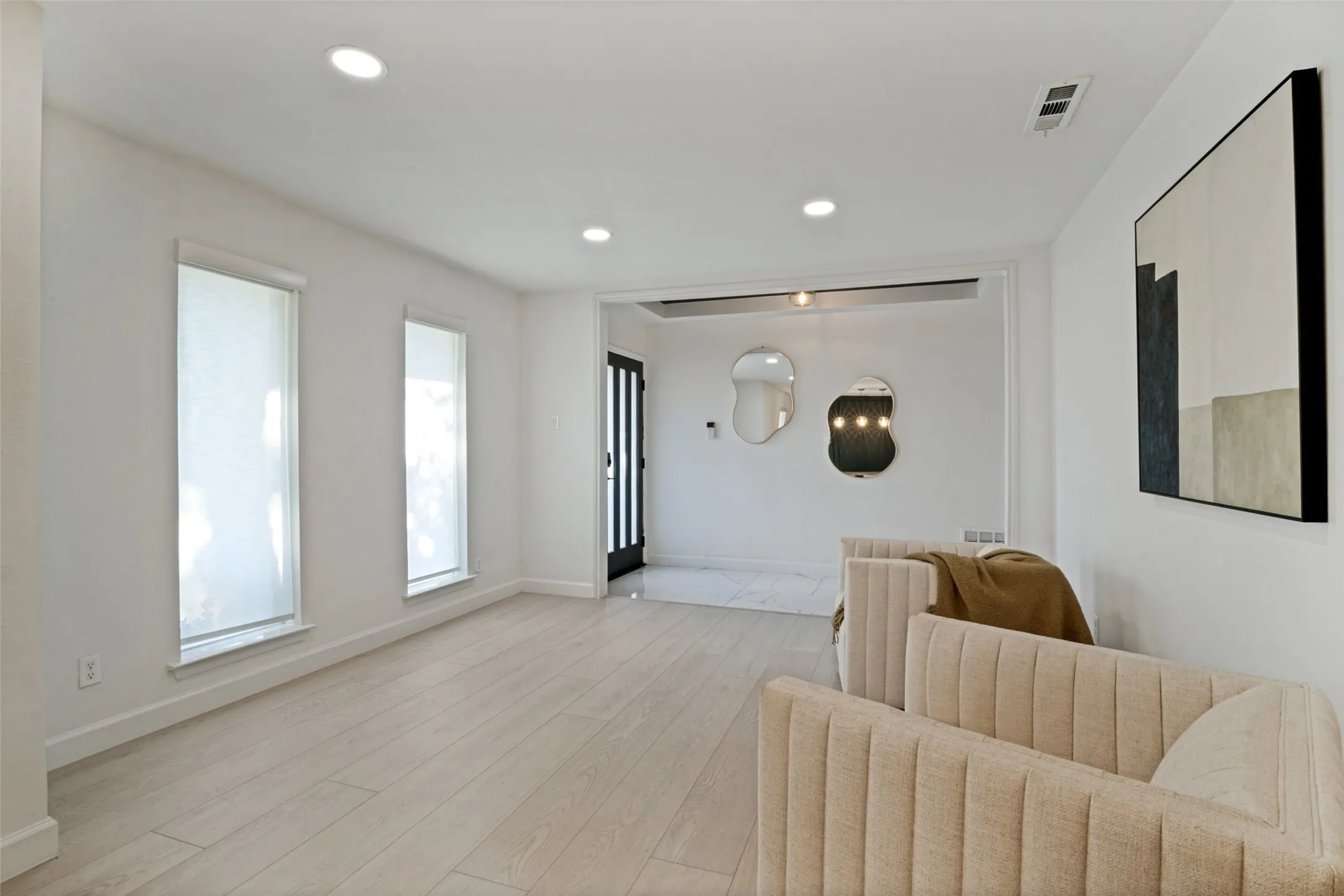 Recessed lighting, wood-finish flooring, and white walls