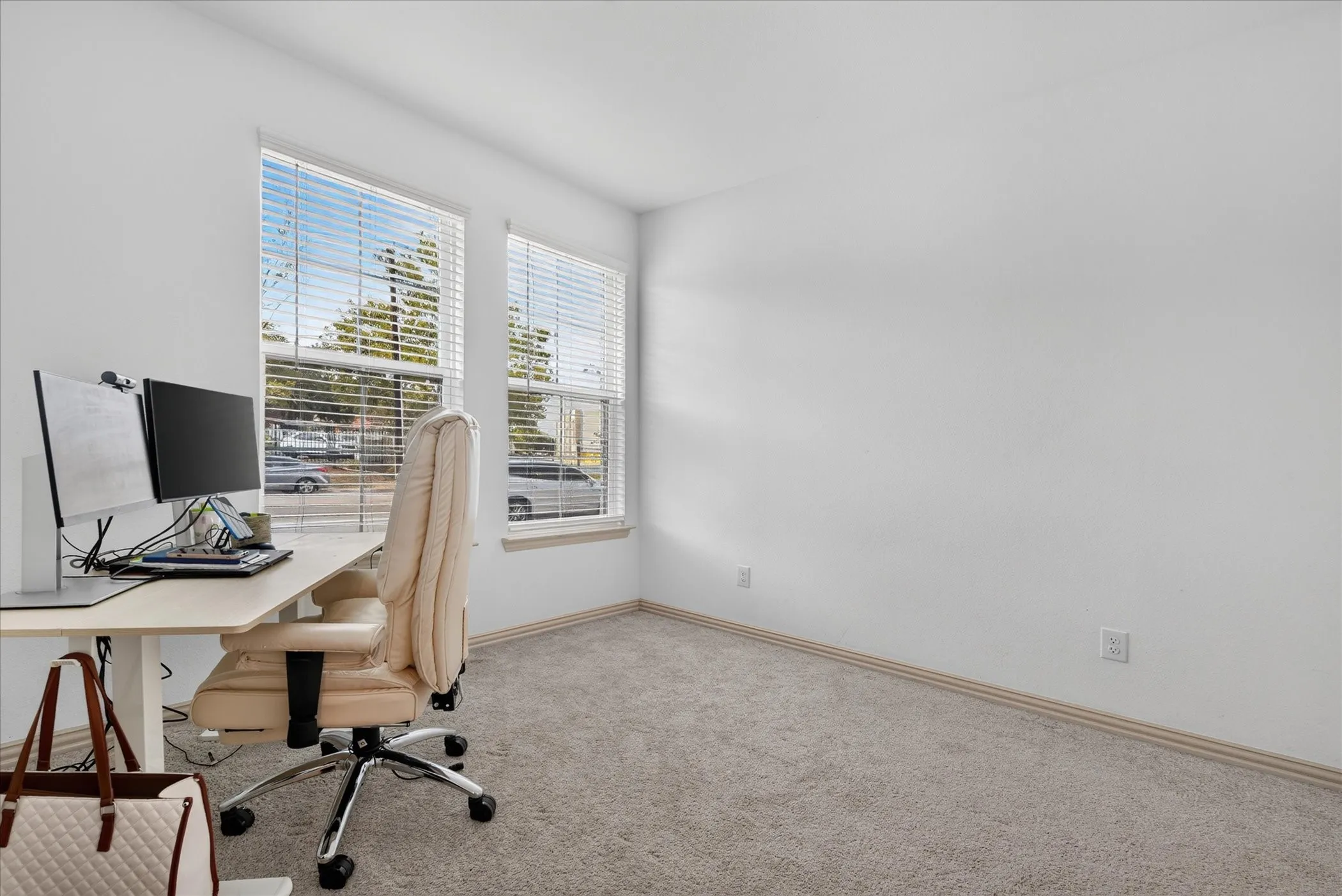 Neutral wall finishes and light-toned carpet flooring