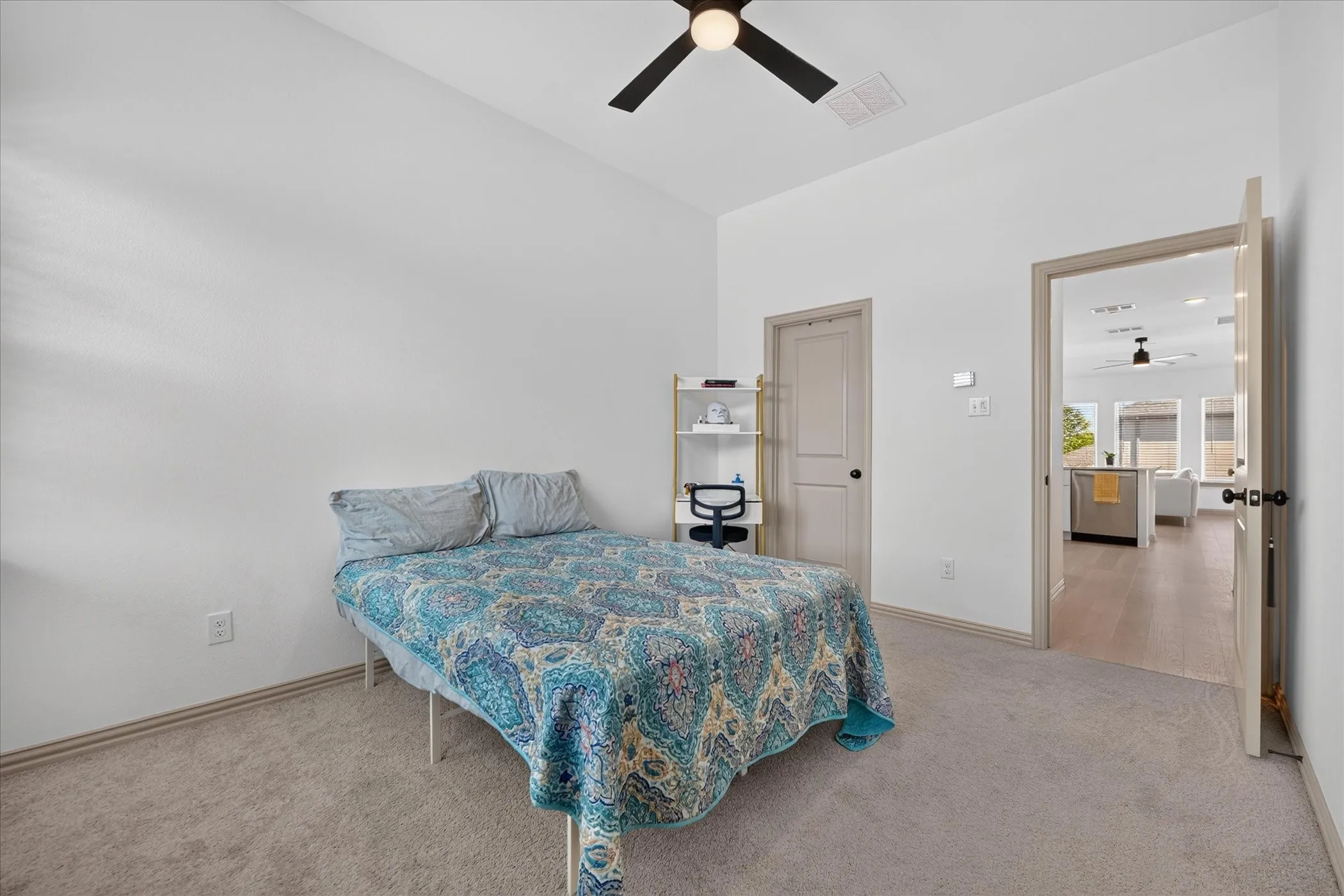 Light-colored carpeting, vaulted ceiling, and ceiling fan with integrated lighting