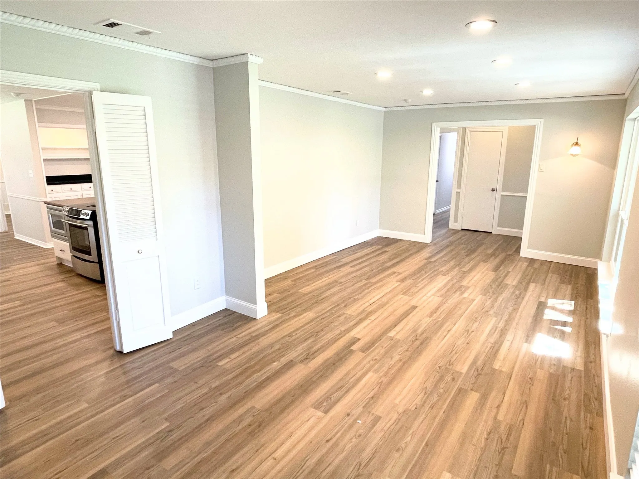 Dining/Living room featuring light hardwood / wood-style floors and ornamental molding