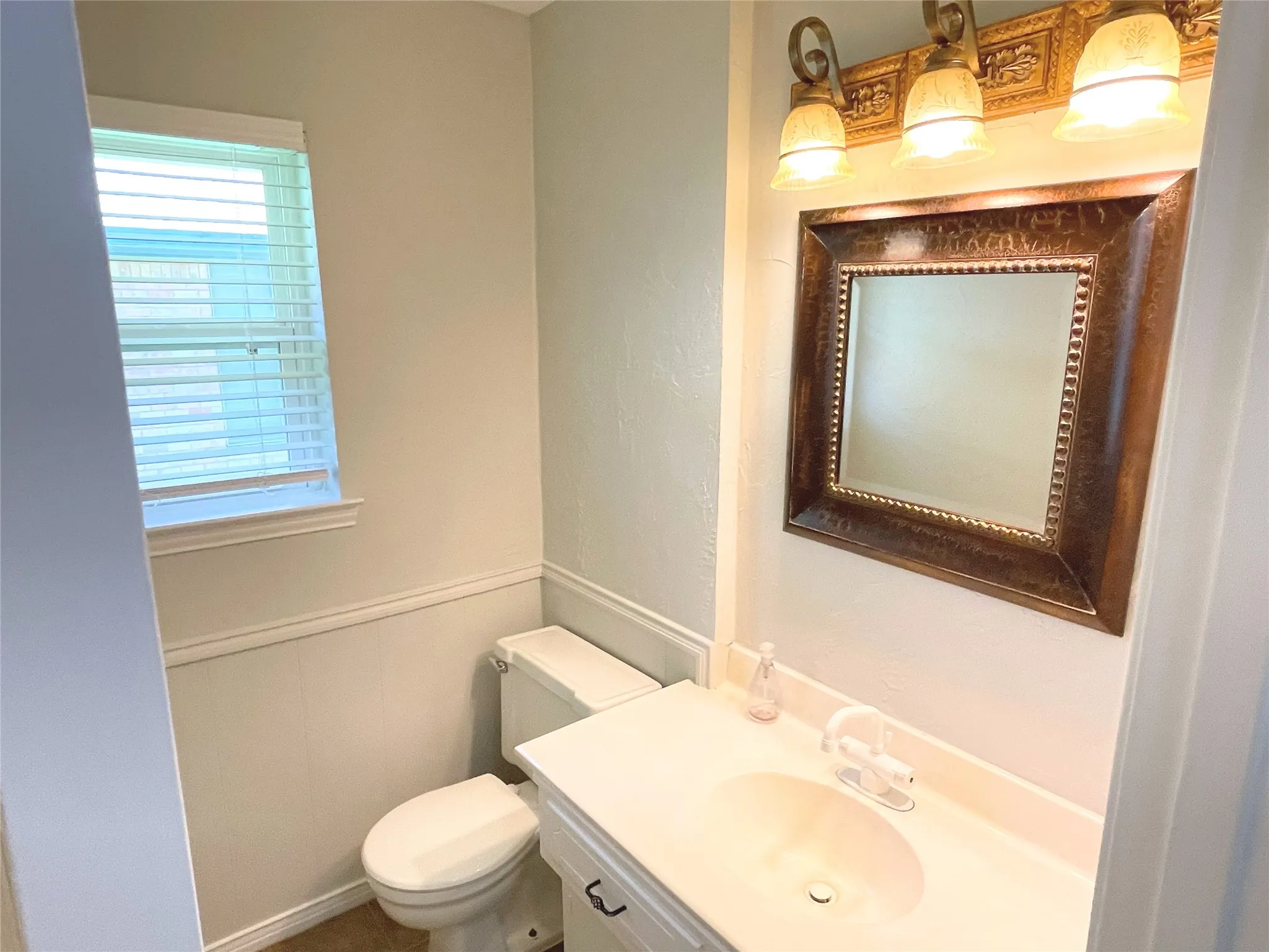 1/2 Bathroom with vanity and toilet